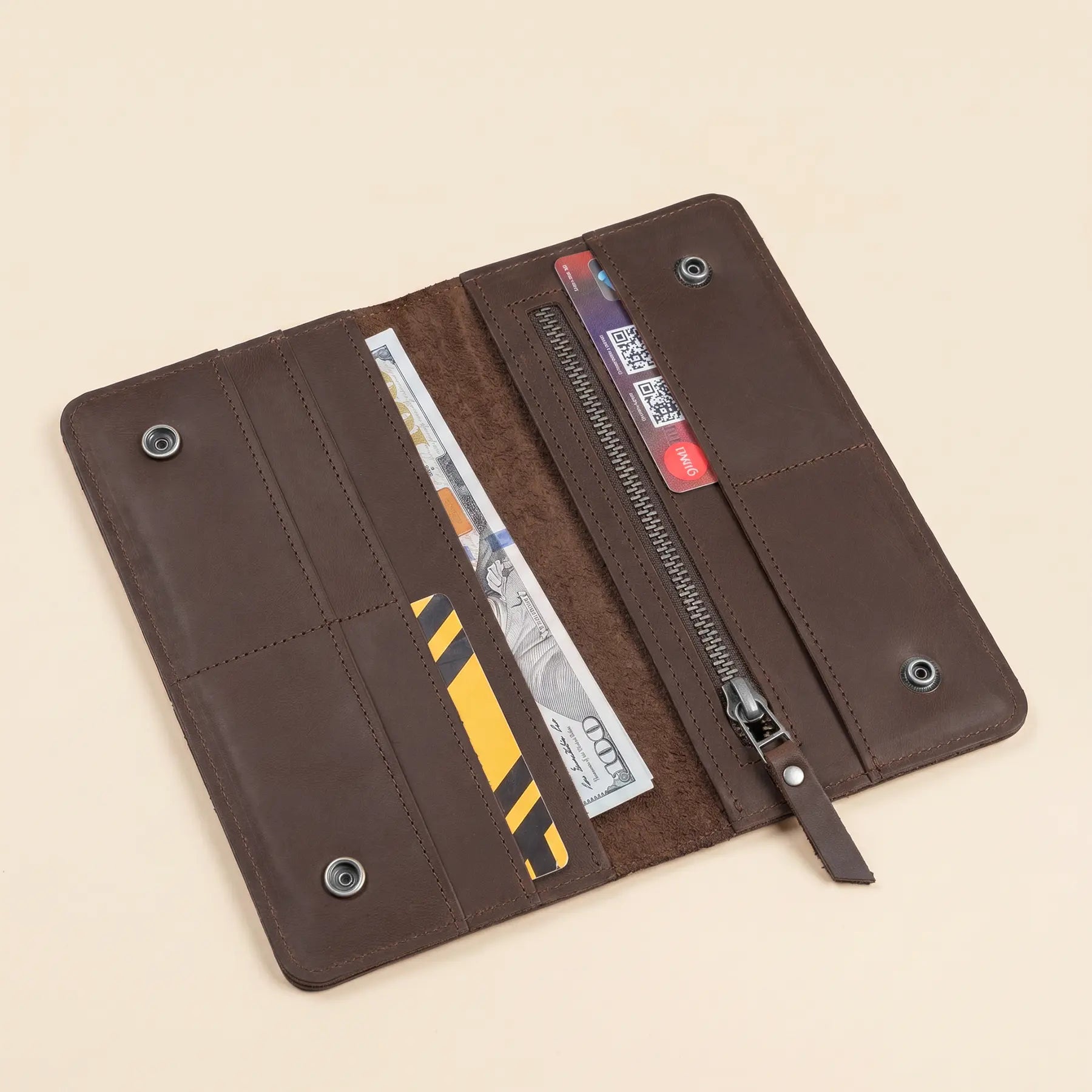 Long genuine leather wallet with practical snap closure and thoughtfully organized interior compartments throughout.