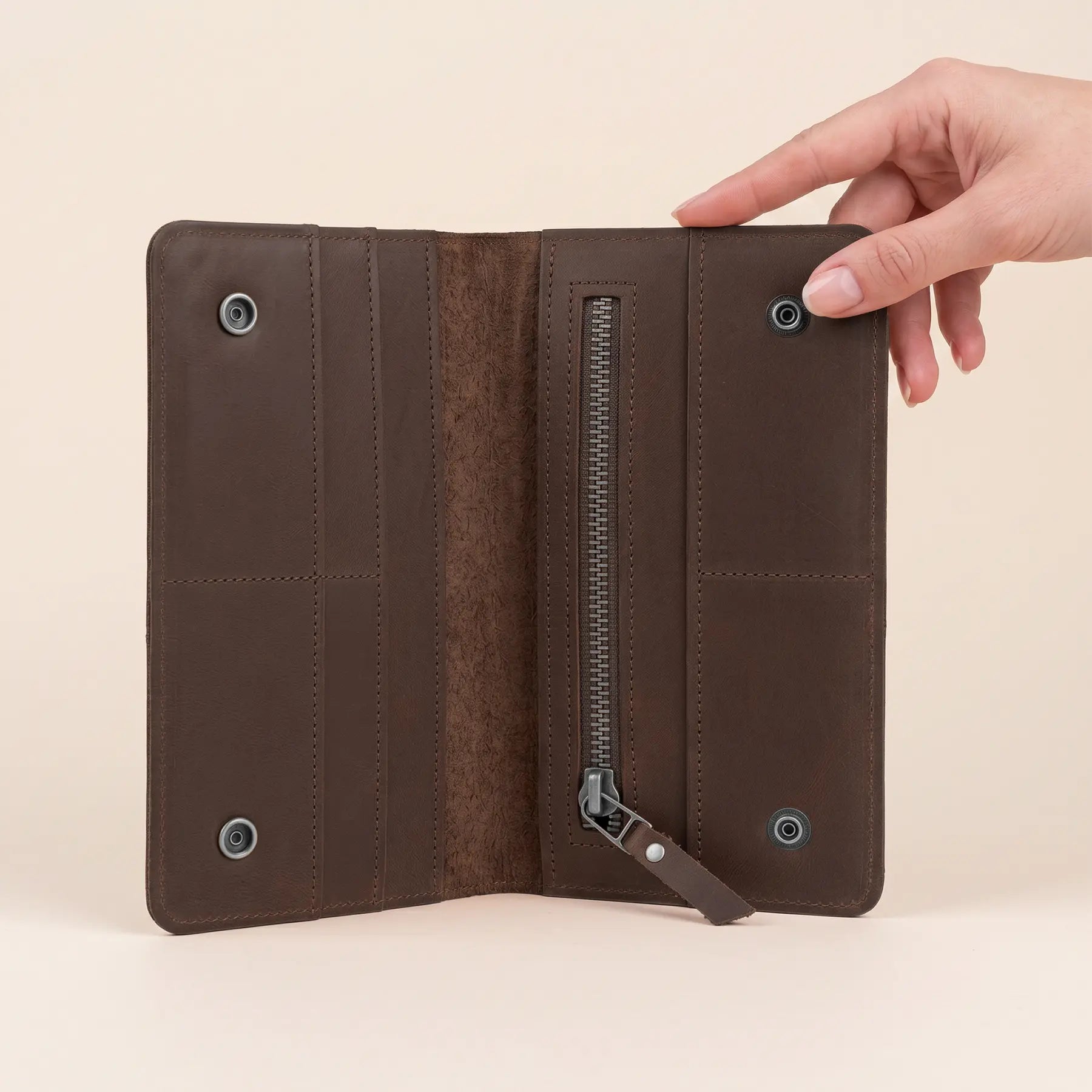 Handmade leather wallet featuring secure snap closure, premium craftsmanship, and organized storage compartments inside.