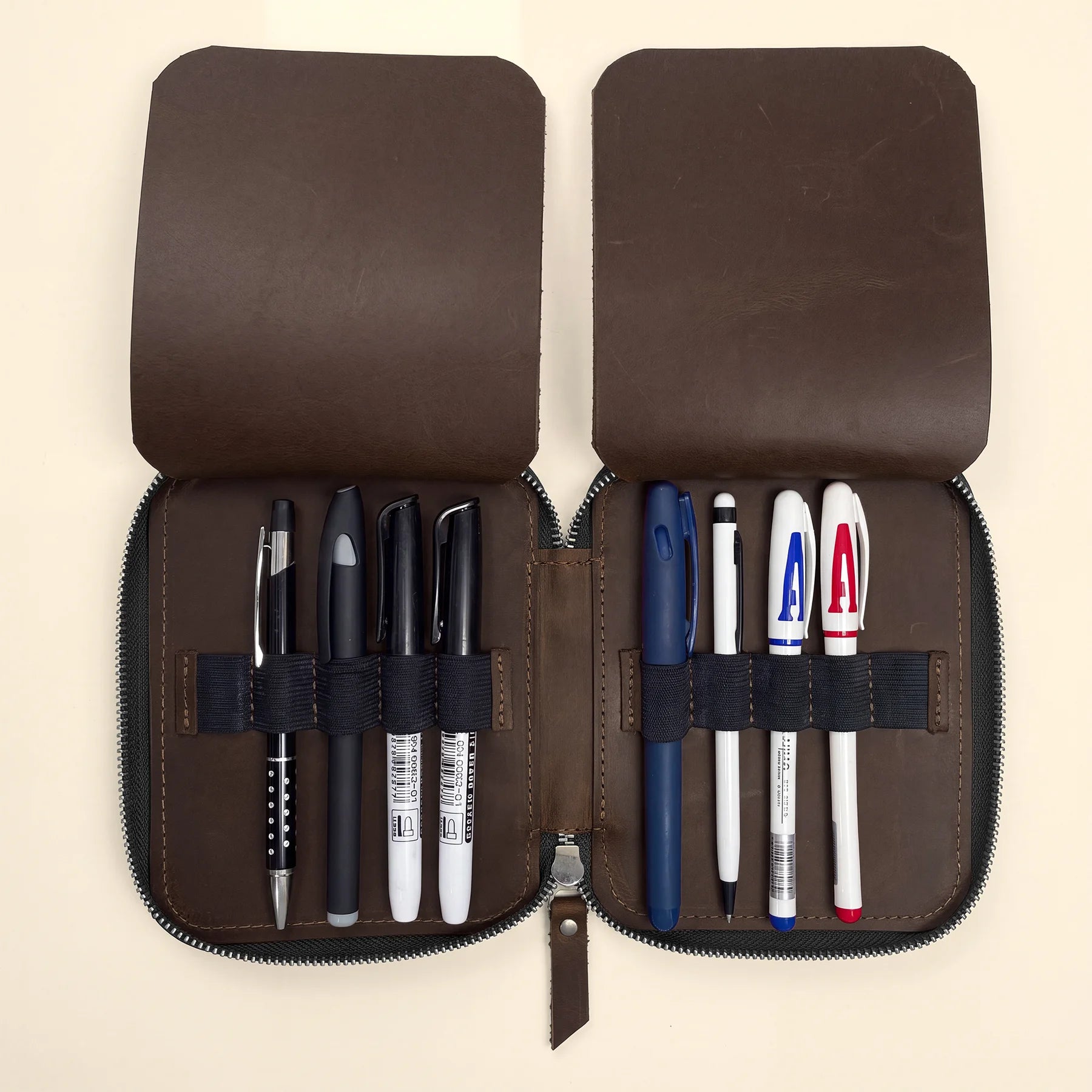 Genuine leather zipper pouch for pens, pencils, markers, and writing accessories.