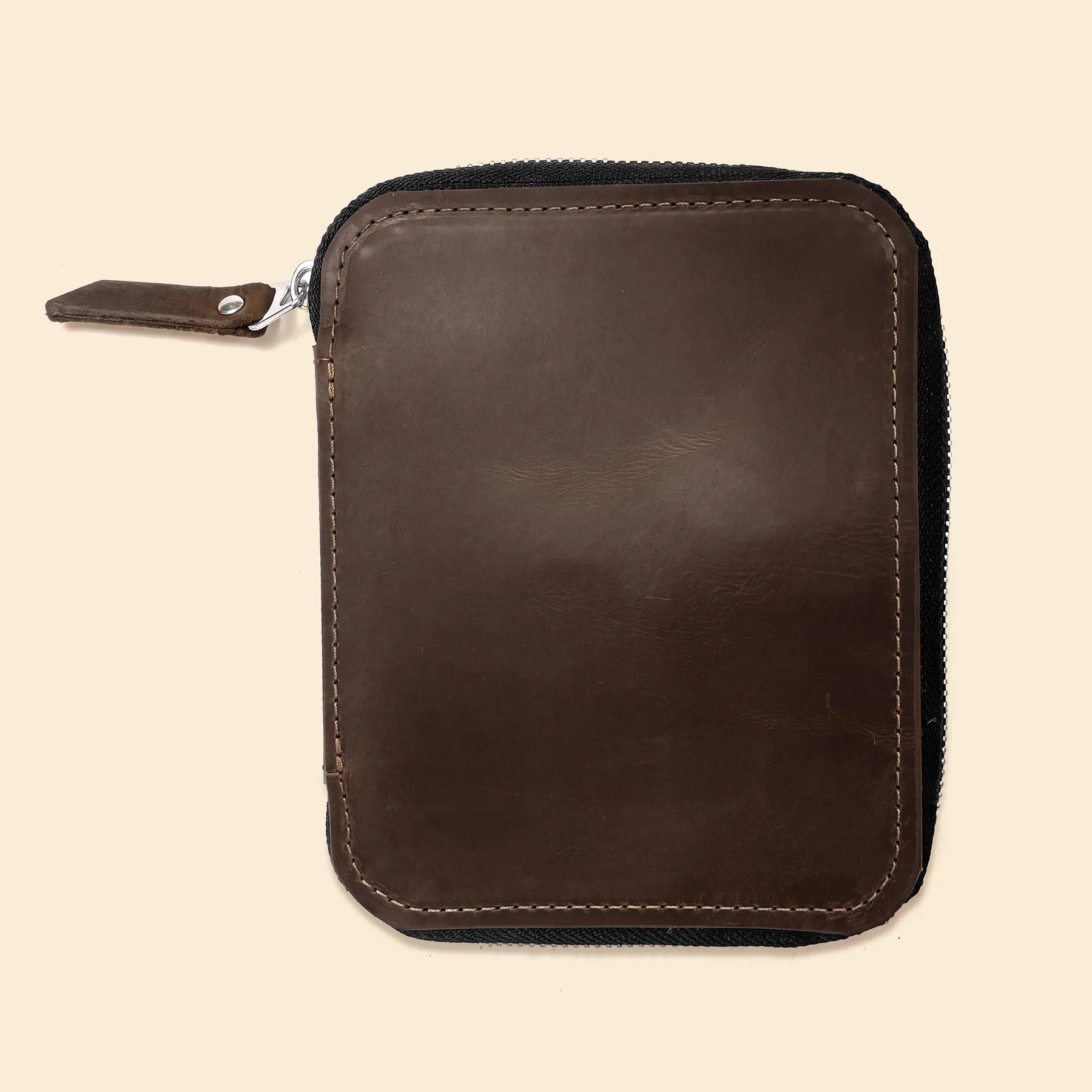 Handmade leather pen case with smooth zipper and soft natural leather texture.