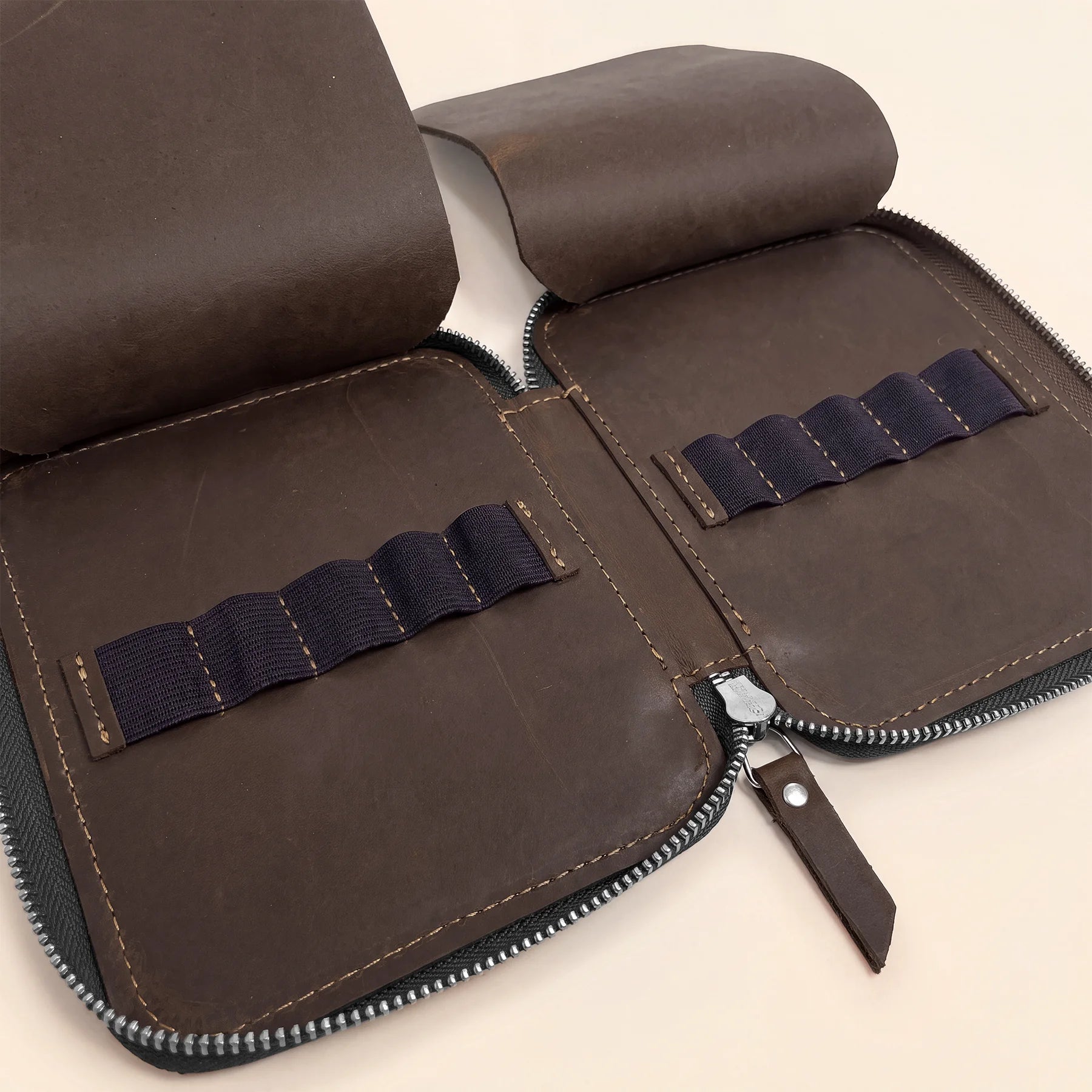 Compact genuine leather pencil pouch with secure zipper for organized stationery storage.