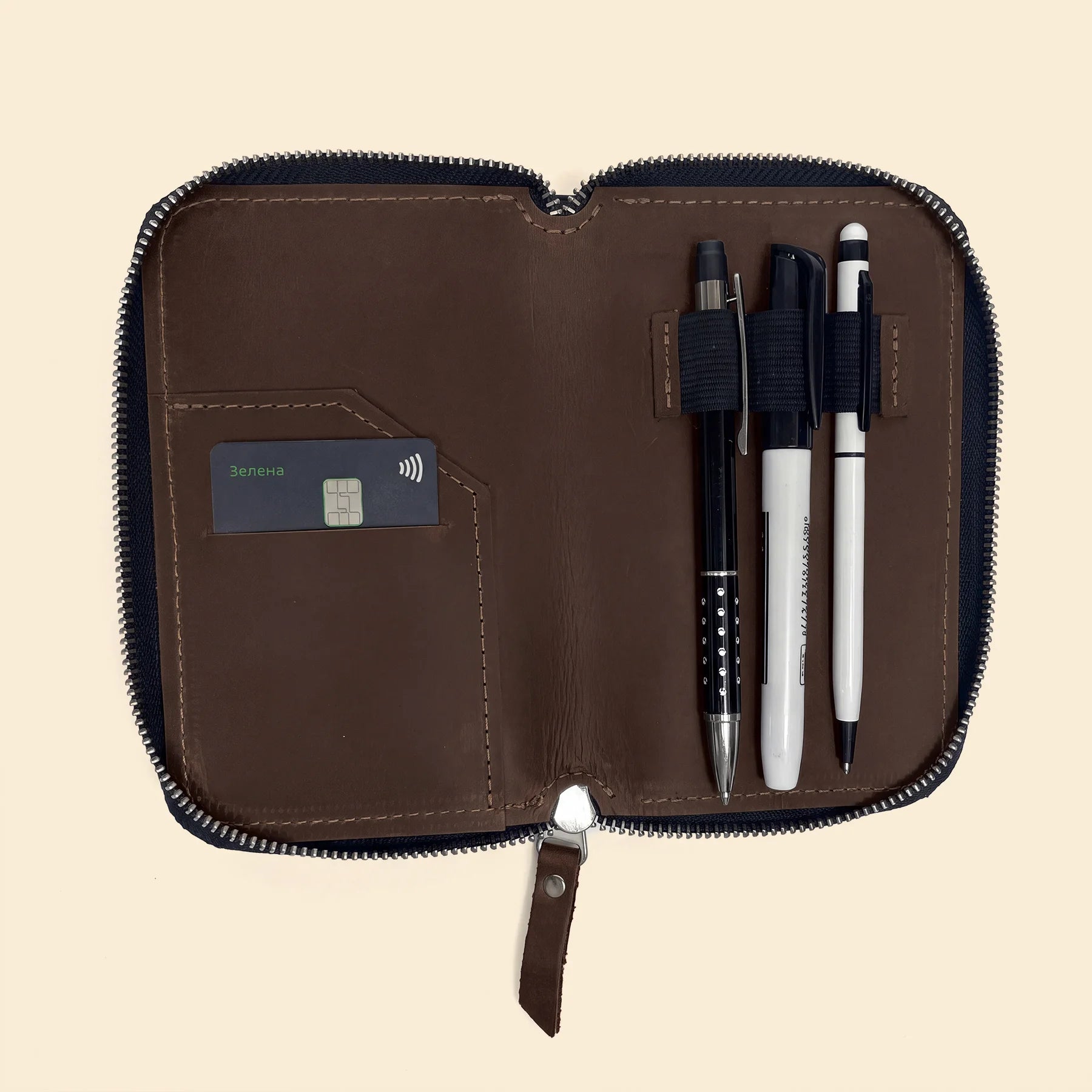 Genuine leather pencil organizer featuring secure zipper and minimalist everyday design.
