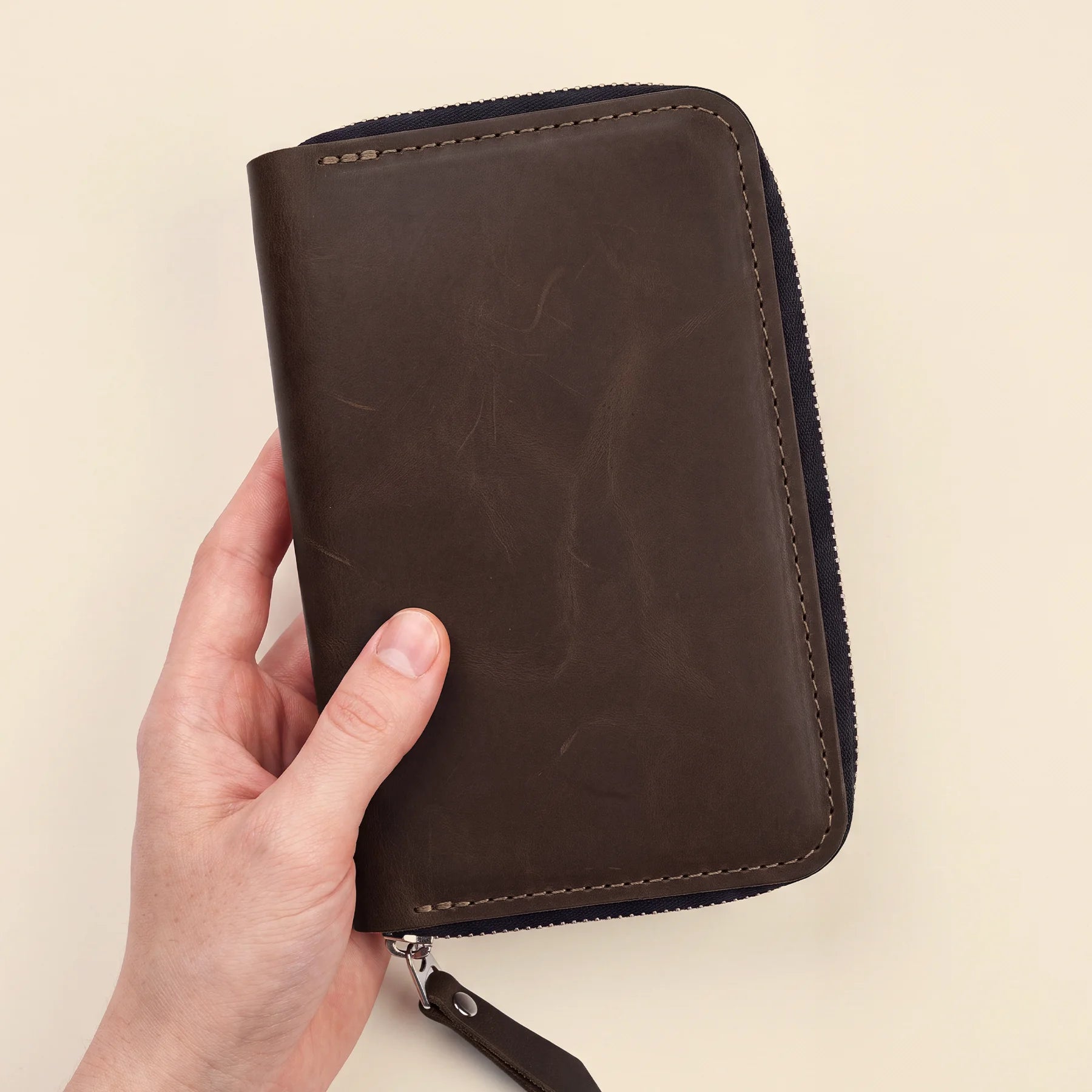 Leather stationery pouch with zipper crafted for stylish pen storage and travel.