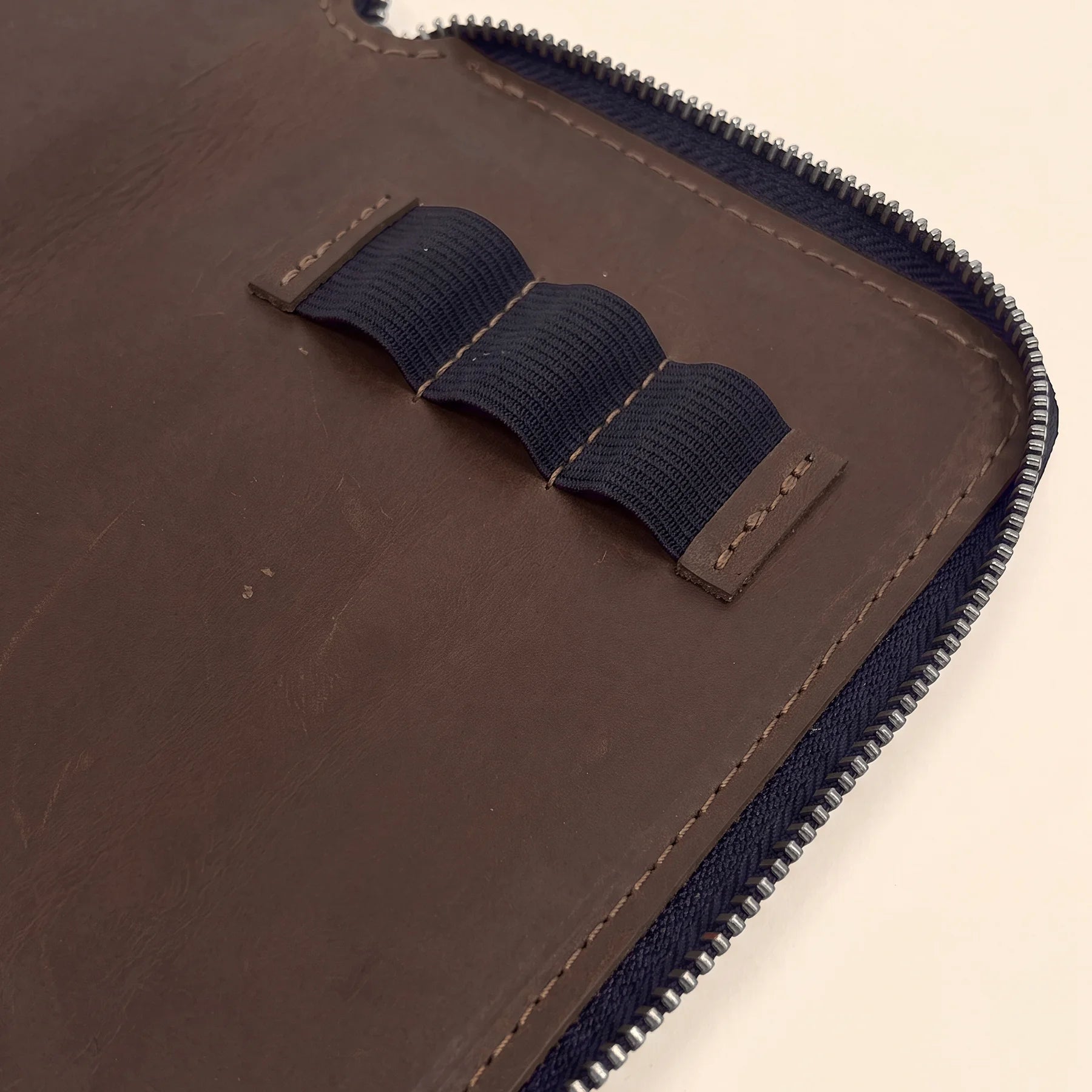 Handcrafted leather pen case offering secure zipper closure and lasting durability.