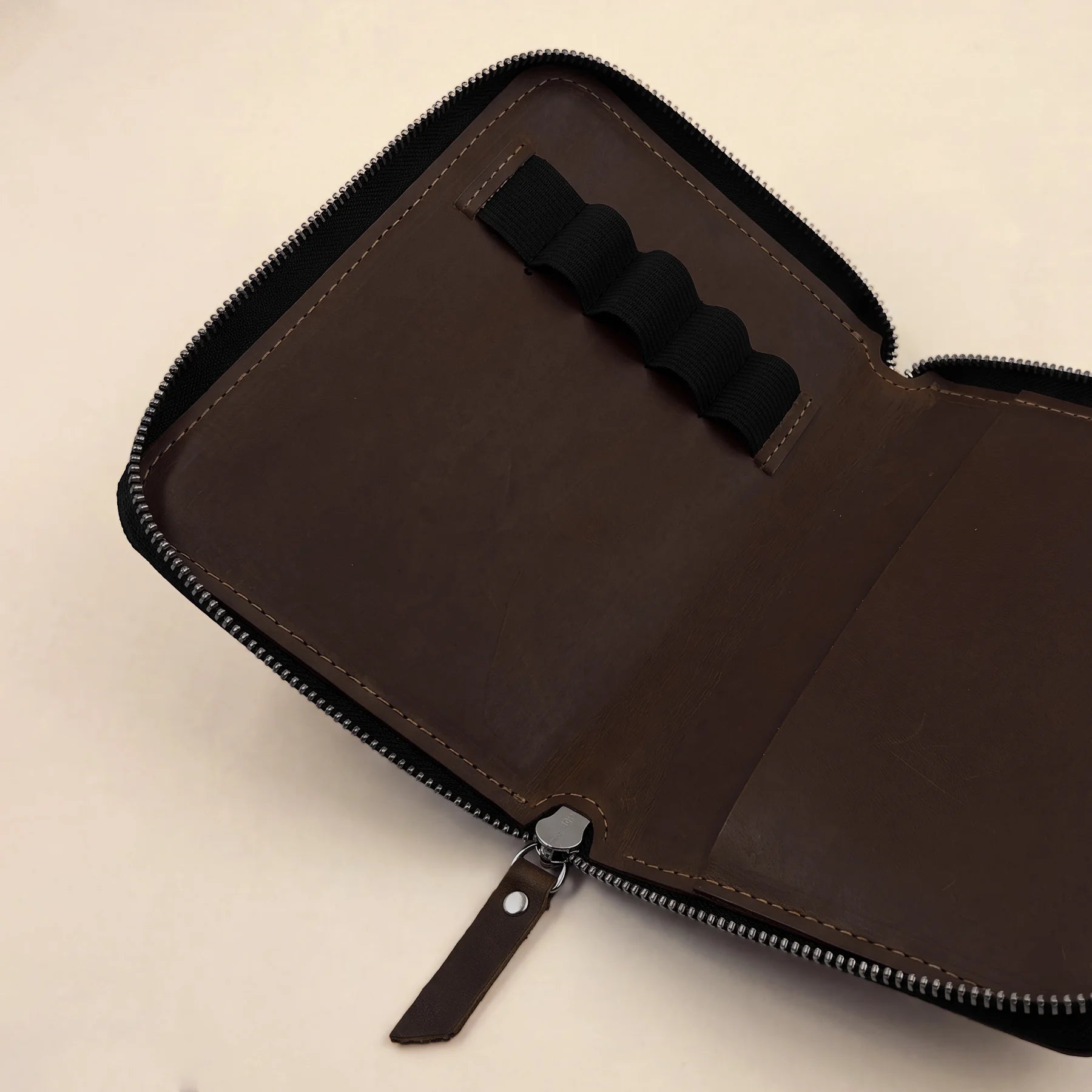 Handmade leather utility pouch with zip designed for stationery and creative tools.