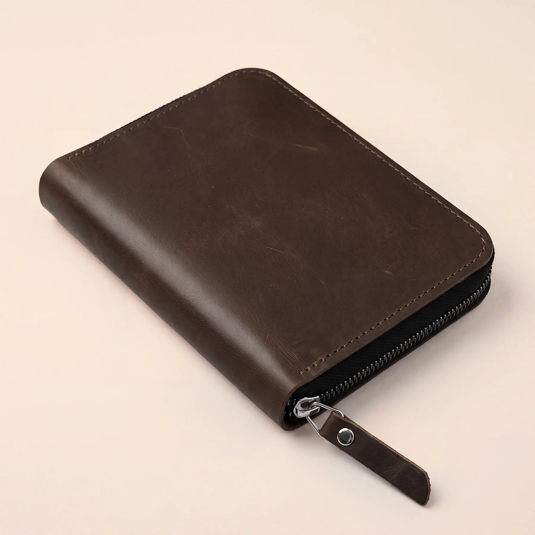 Refined leather pencil organizer with secure zipper and premium natural leather finish.