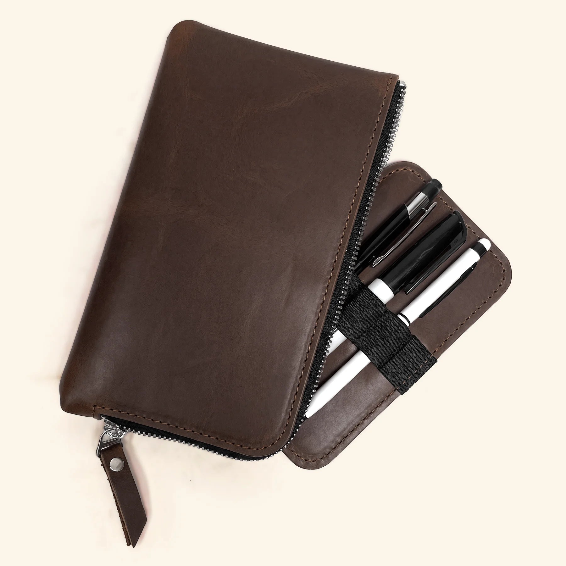 Hand-finished leather pen case with durable zipper and premium natural texture.
