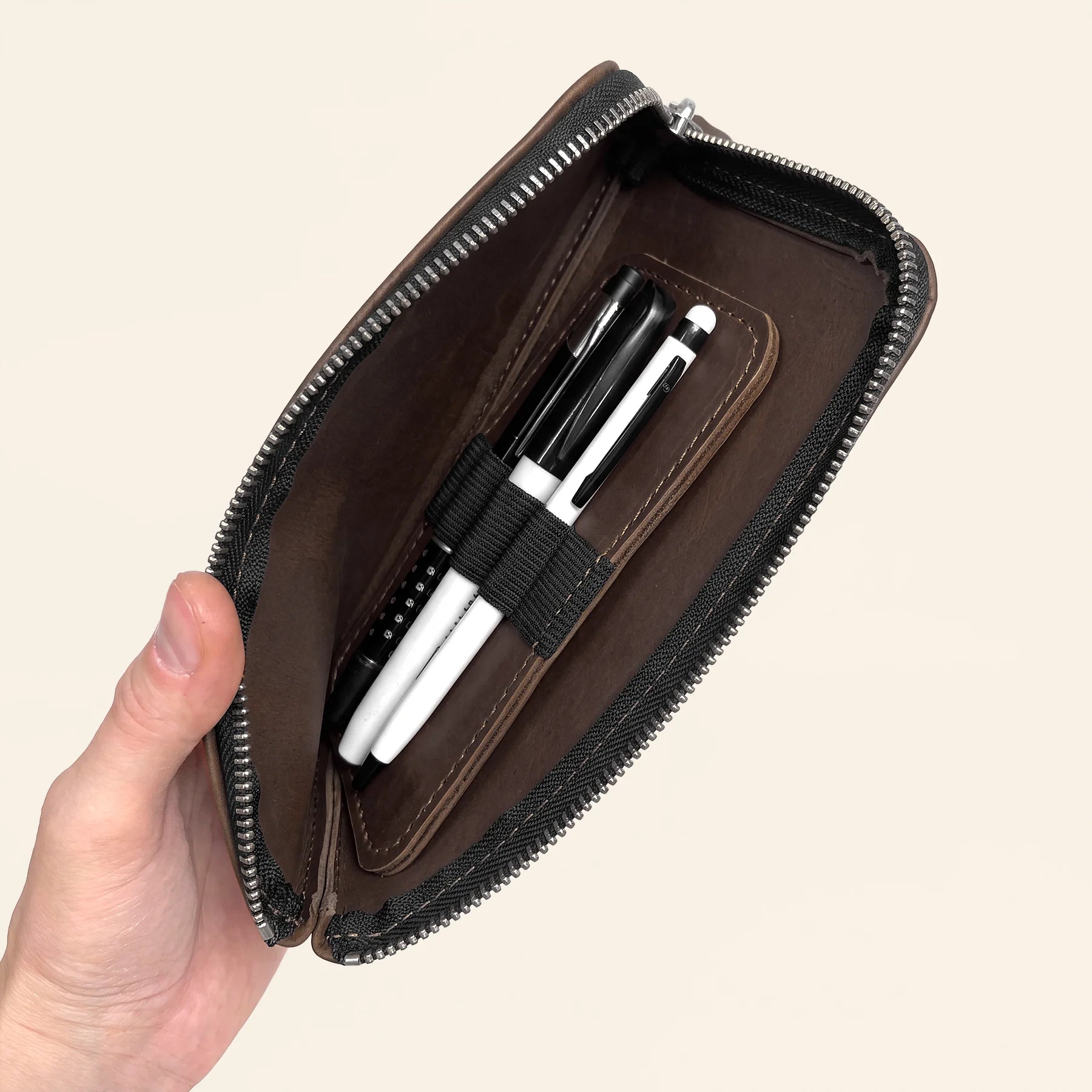 Stylish leather writing gear case with zipper for professional everyday carry.