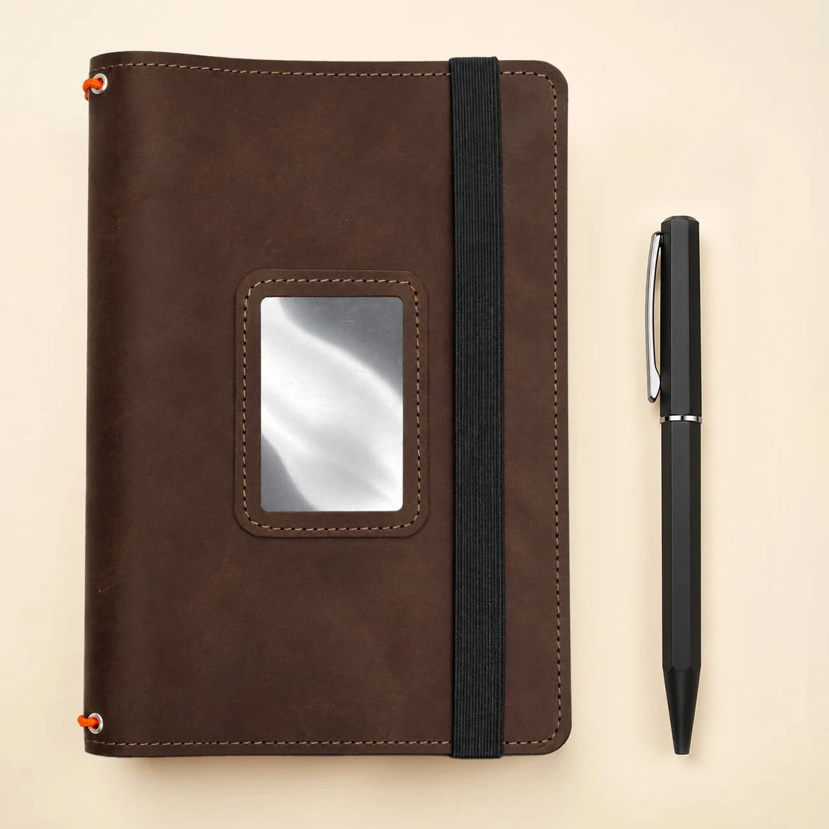 Genuine leather notebook case with three elastic notebook holders and spacious storage compartments.