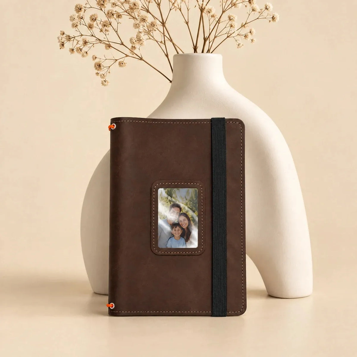 Handmade genuine leather notebook cover with three elastic bands, pockets, and transparent photo window.