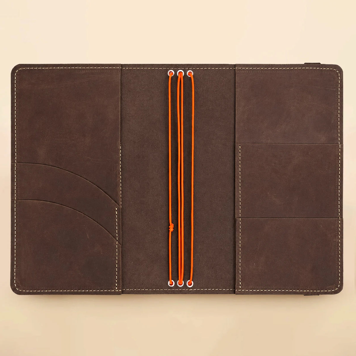 Leather journal with three elastic straps, convenient internal pockets, and a transparent exterior picture sleeve.