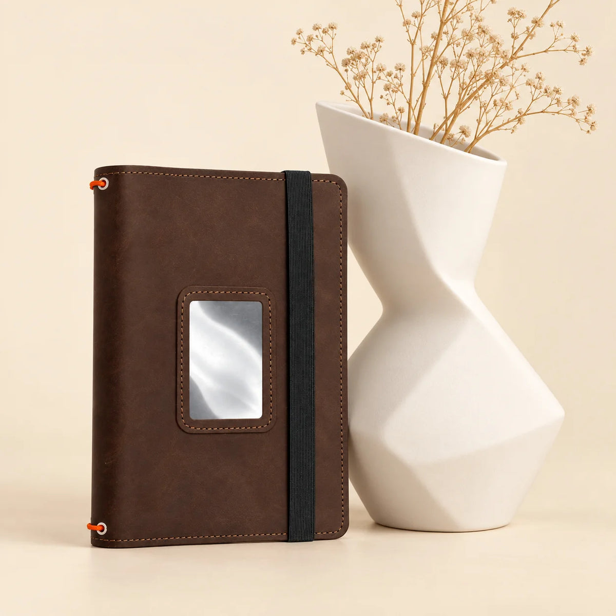 Leather notebook cover featuring three elastic bands and multiple practical pockets inside.
