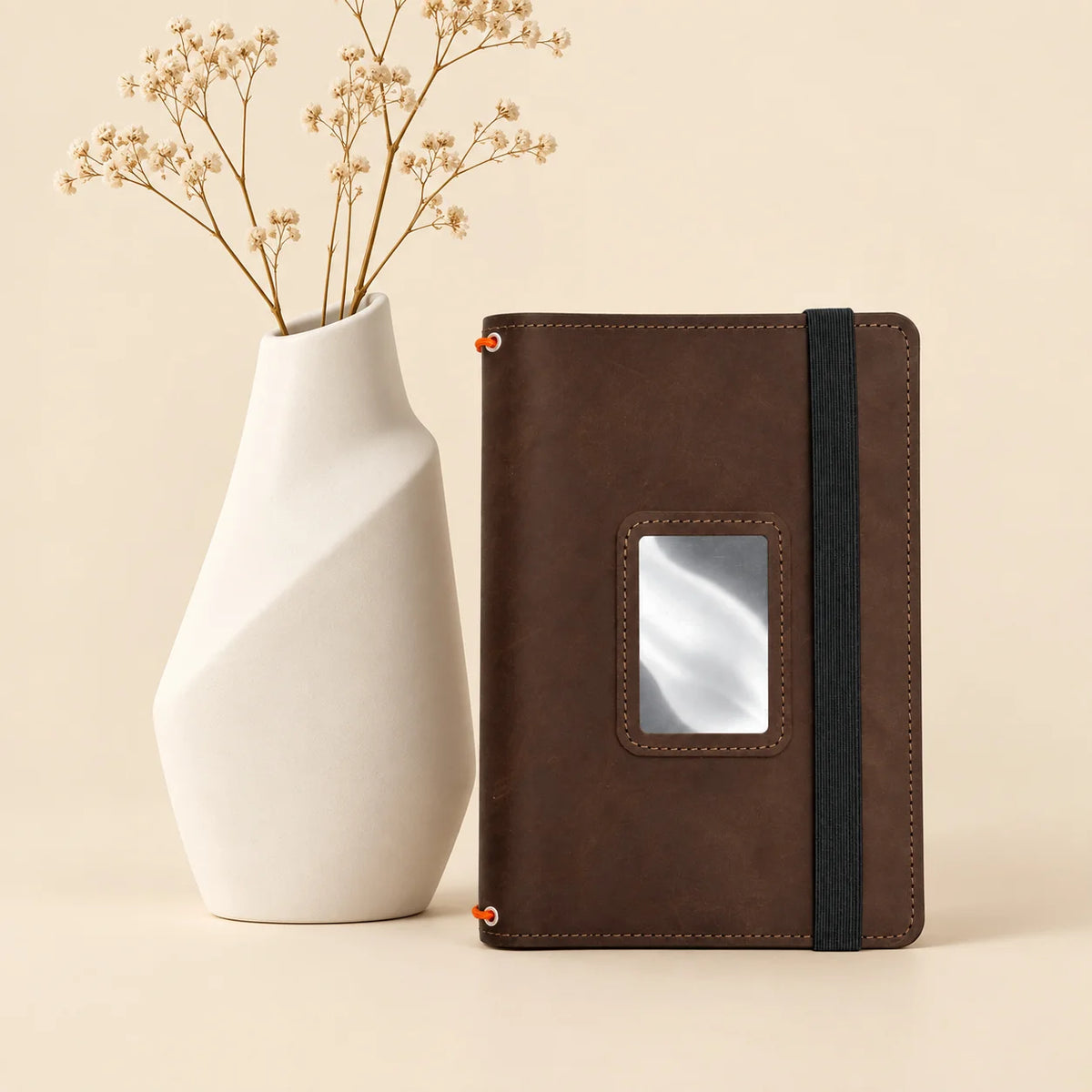 Natural leather journal cover featuring inner pockets and three secure elastic notebook bands.