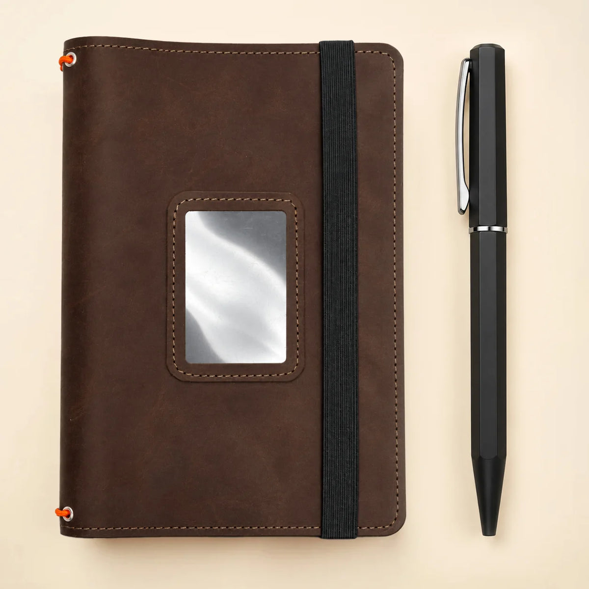 Handmade leather notebook cover with spacious pockets and three elastic closure bands.