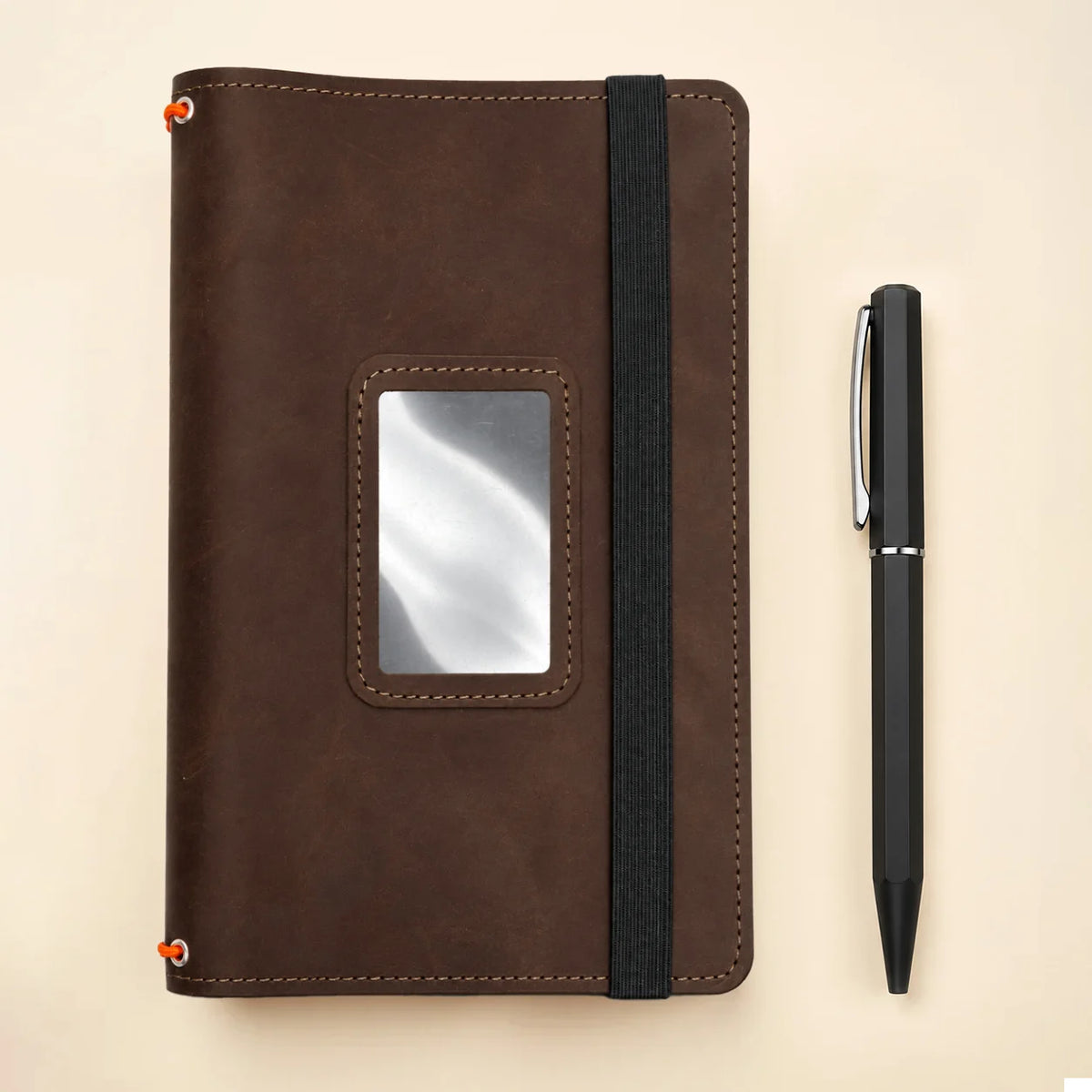 Genuine leather notebook organizer featuring three elastic straps and convenient internal storage pockets.