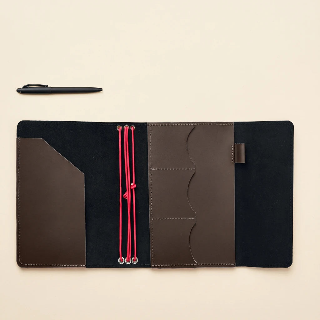 Leather journal cover with elastic straps and secure interior pocket organization