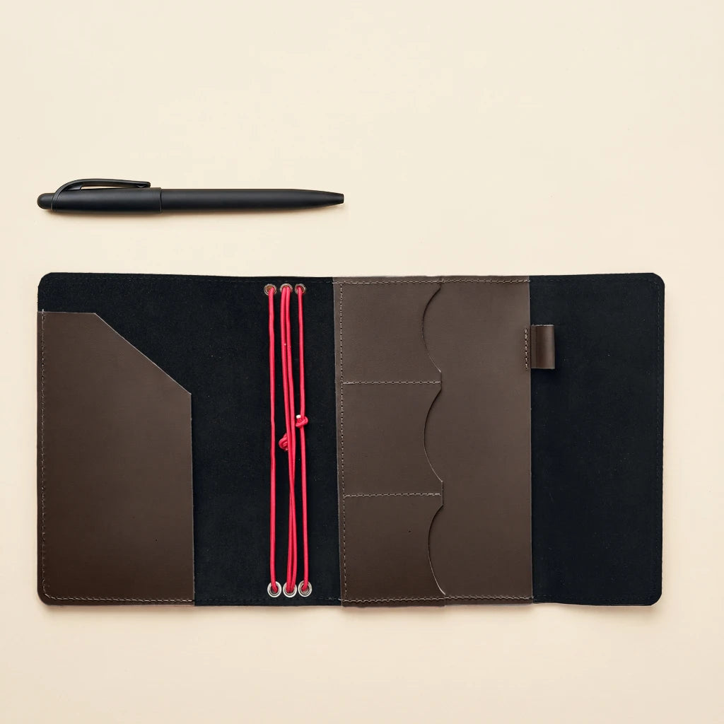 Handmade genuine leather notebook cover with elastic closure and functional inner pockets