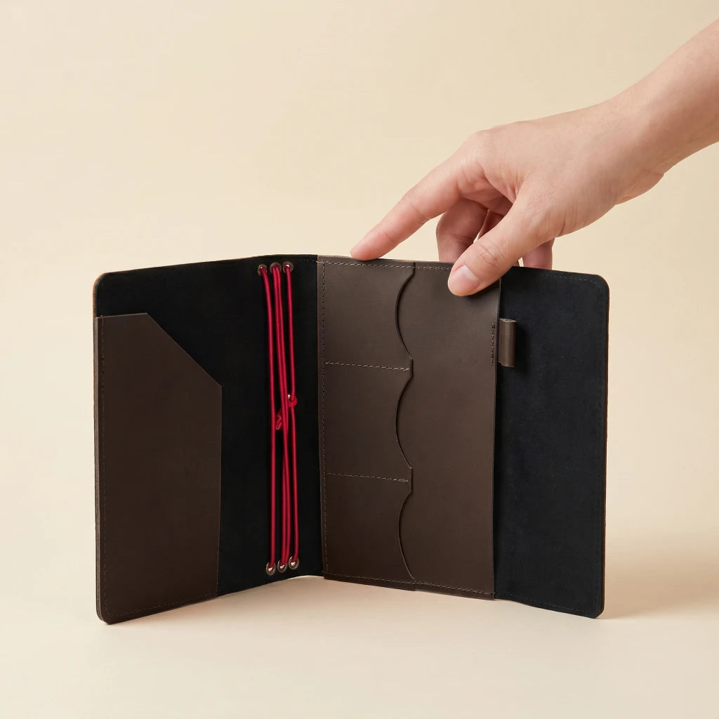 Elegant leather journal cover with elastic straps, practical pockets, and pen holder