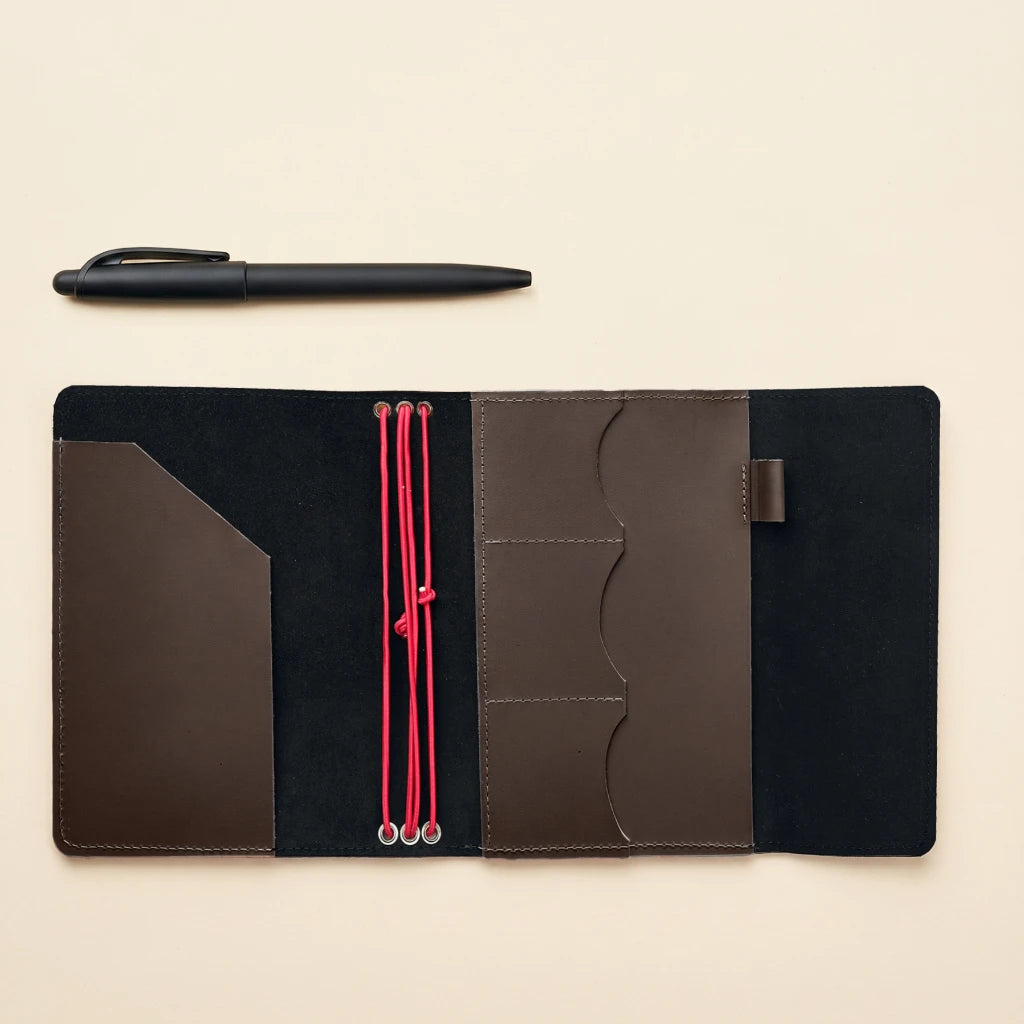 Handmade leather notebook cover with elastic bands and compact journal style