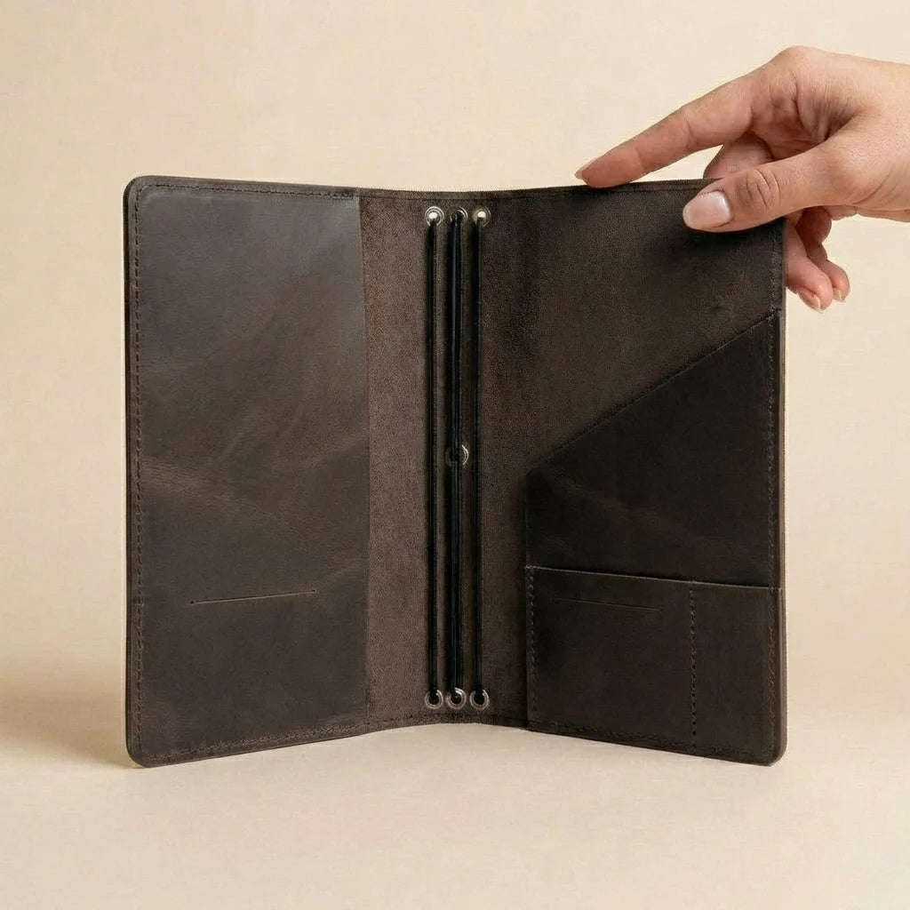 Brown leather wallet with metal clasps on a beige background