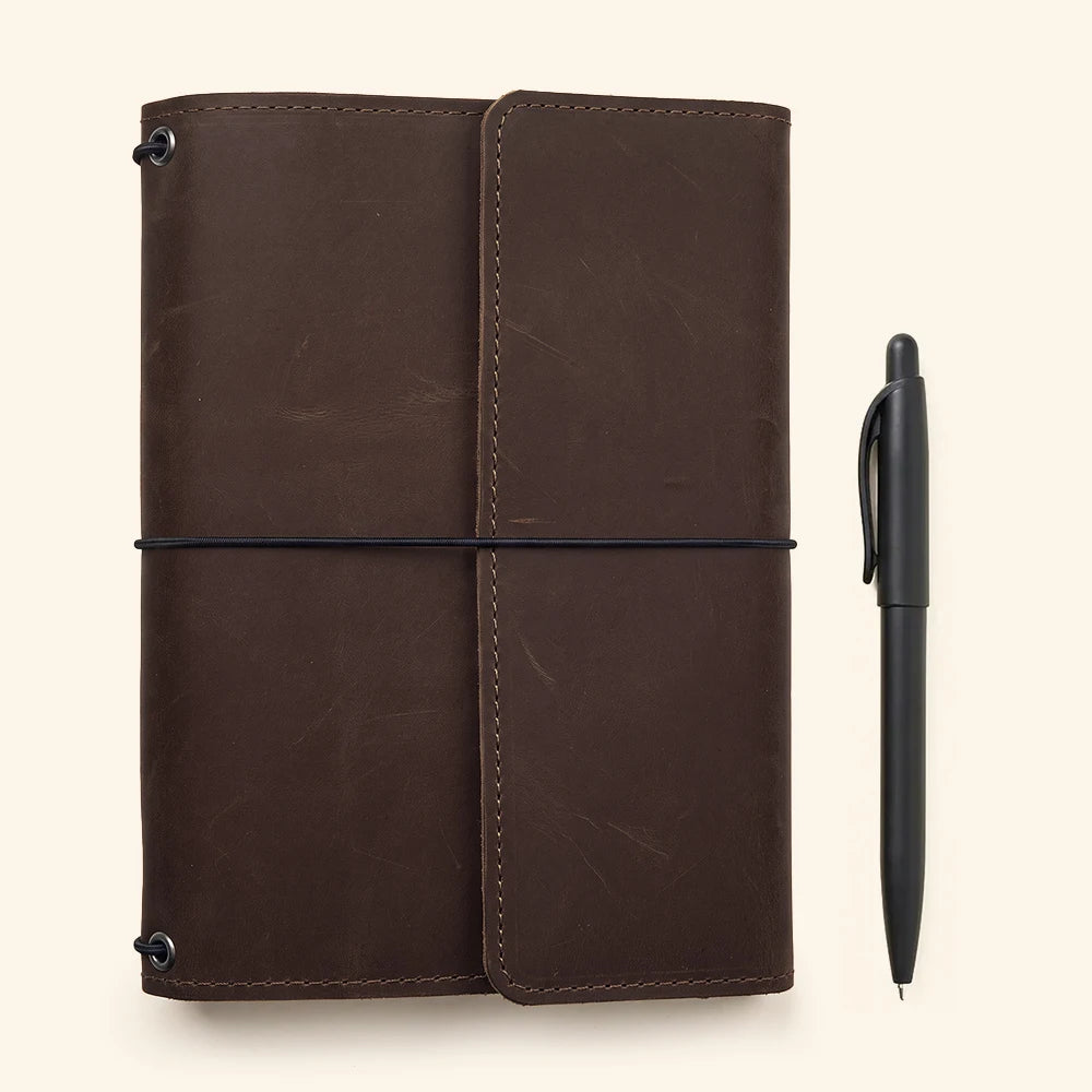 Refillable leather journal sleeve offering practical interior storage and premium leather construction.