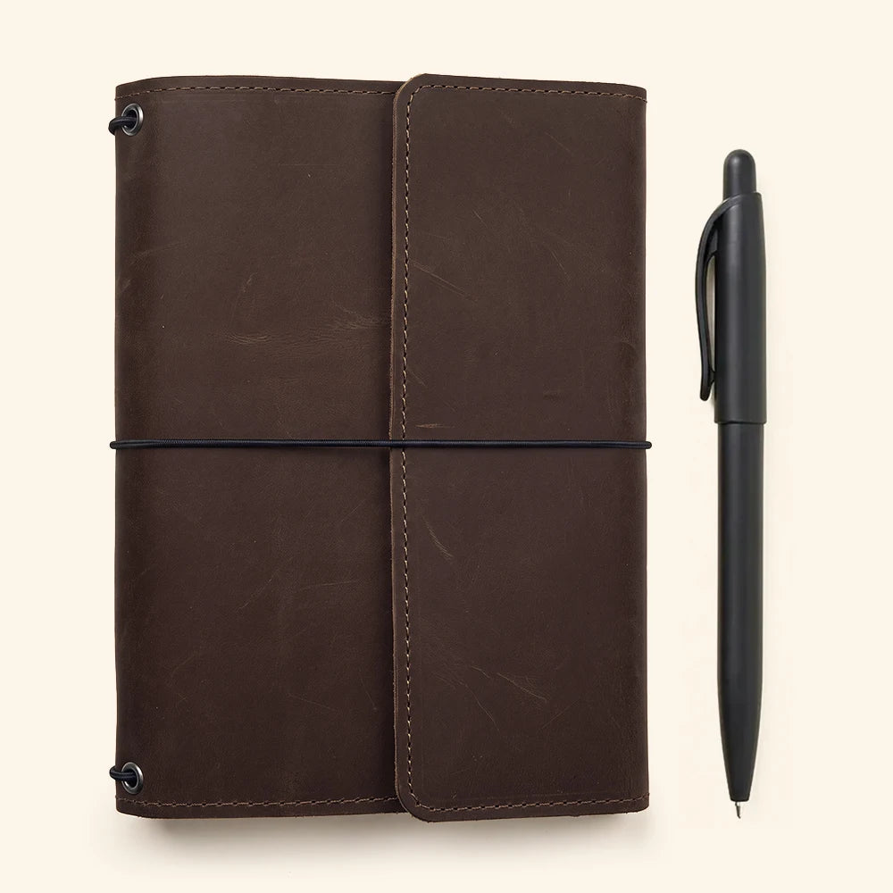 Handcrafted leather notebook cover with elastic insert system and neatly arranged inside pockets.