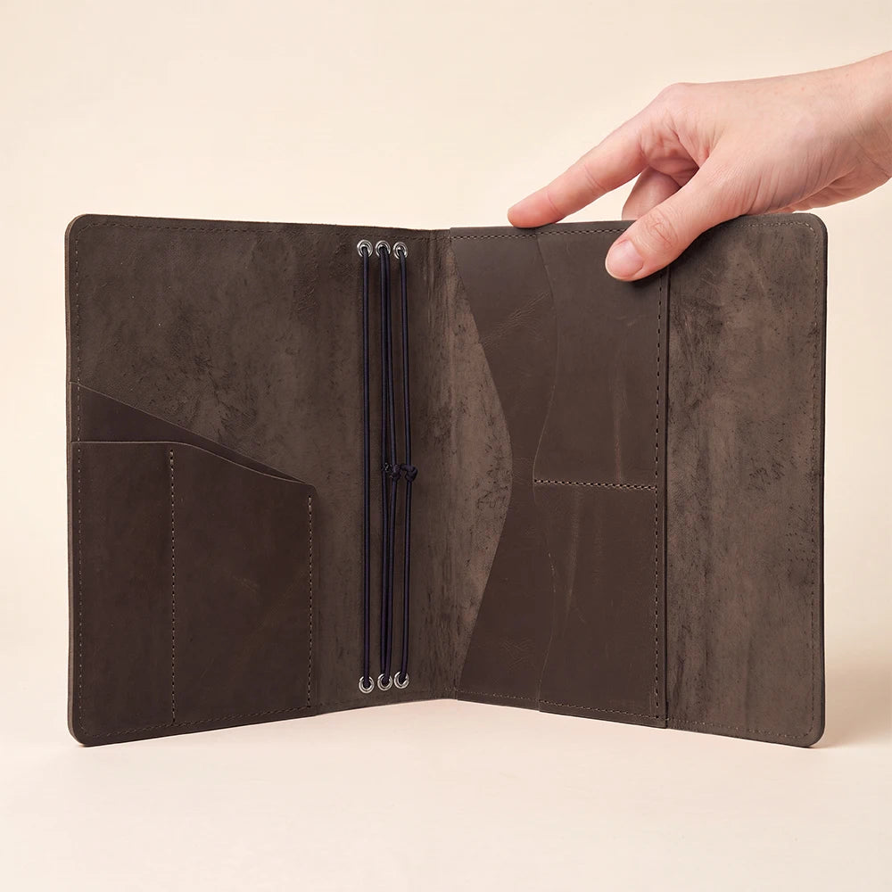 Genuine leather planner cover featuring three elastic bands and convenient inside storage pockets.
