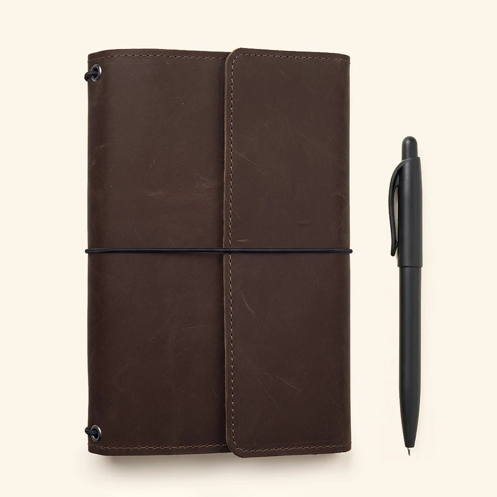 Genuine leather planner organizer with refillable notebook system and functional interior layout.