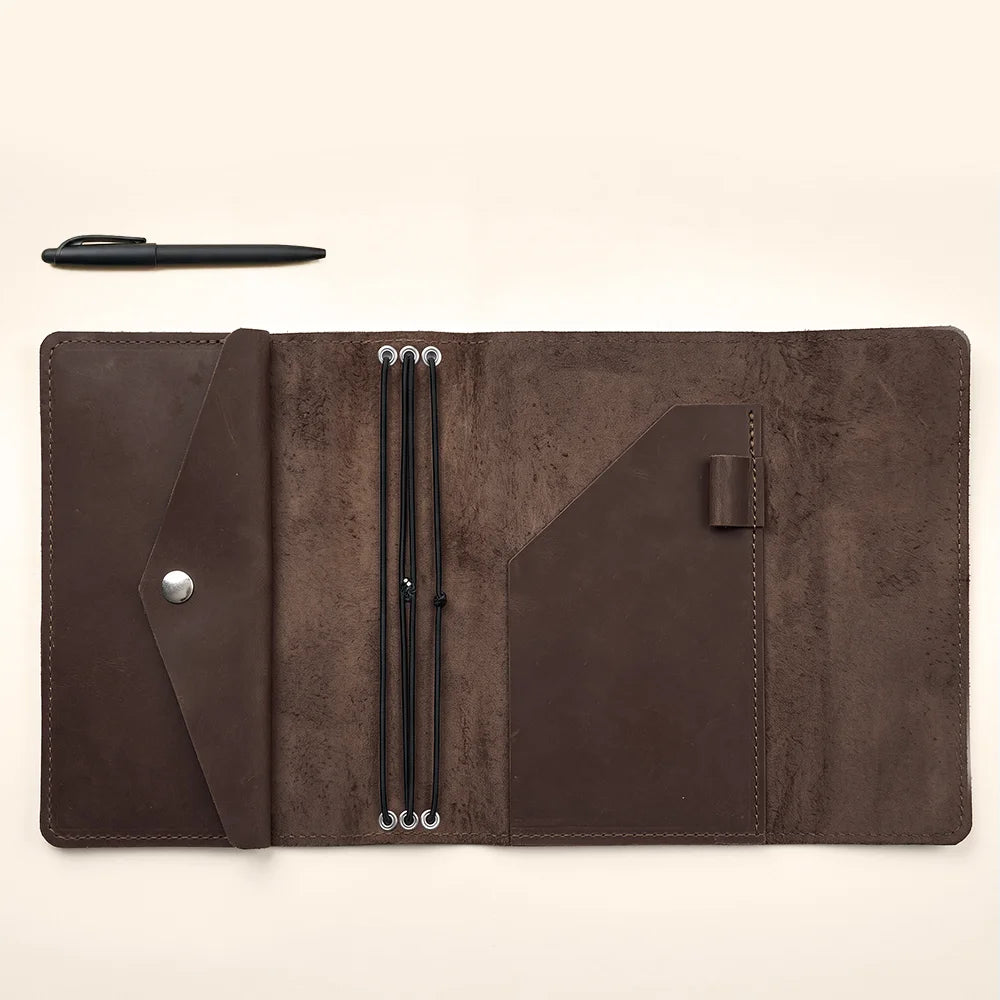 Refillable leather notebook case featuring spacious interior compartments and elegant handcrafted stitching.