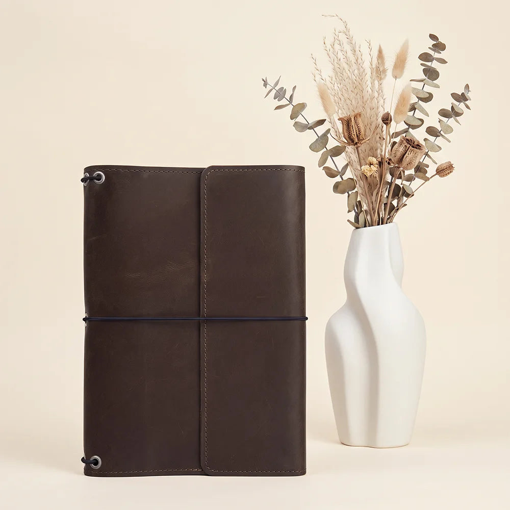 Rustic leather planner cover offering elegant craftsmanship and convenient interior organization features.