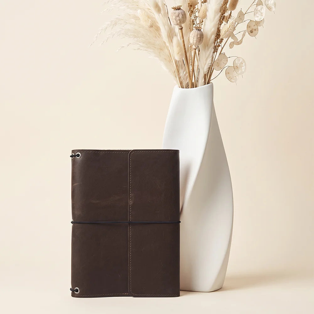 Full grain leather notebook organizer with secure elastic inserts and premium handcrafted construction.