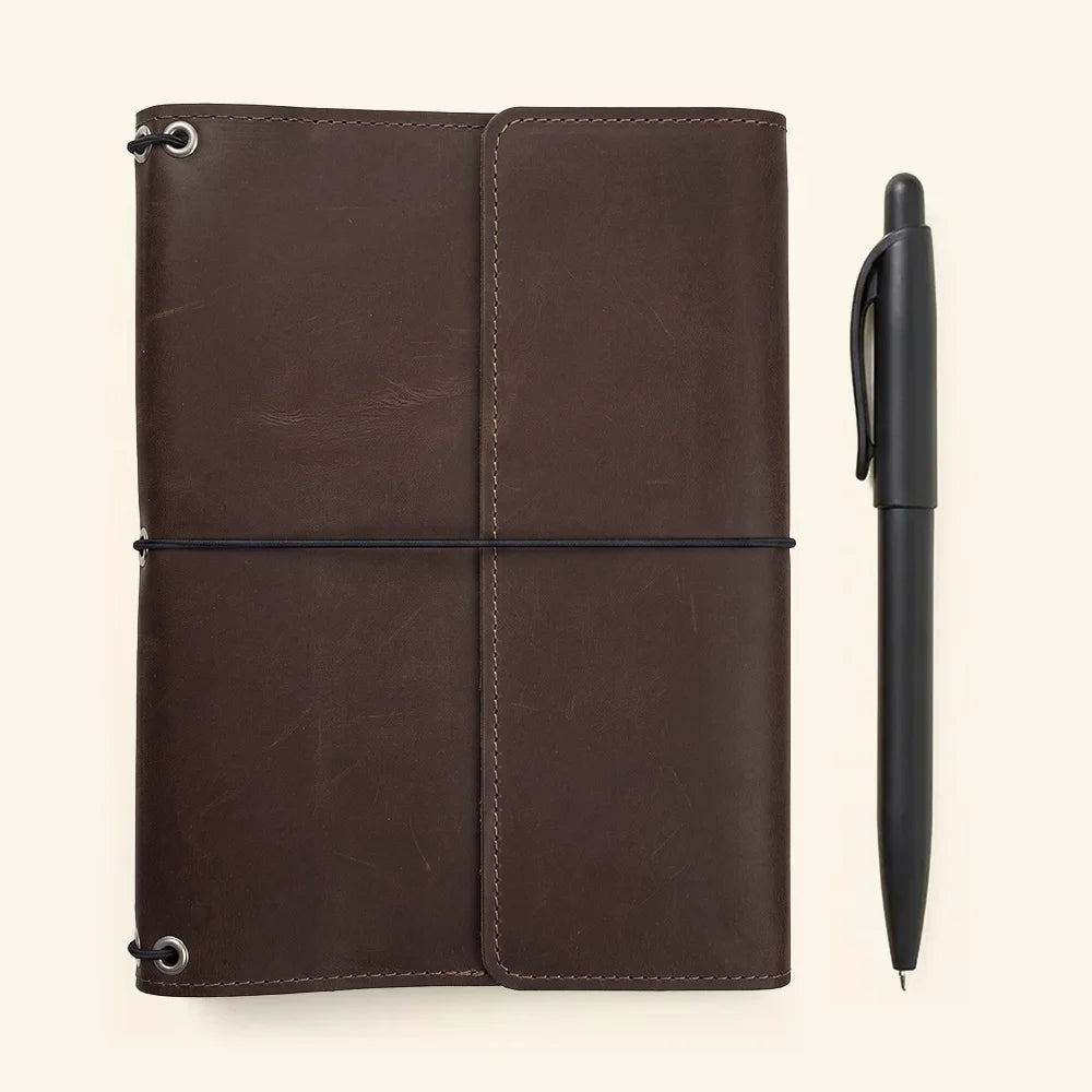 Handcrafted notebook cover in genuine leather with practical organizer pockets and elastic notebook holders.