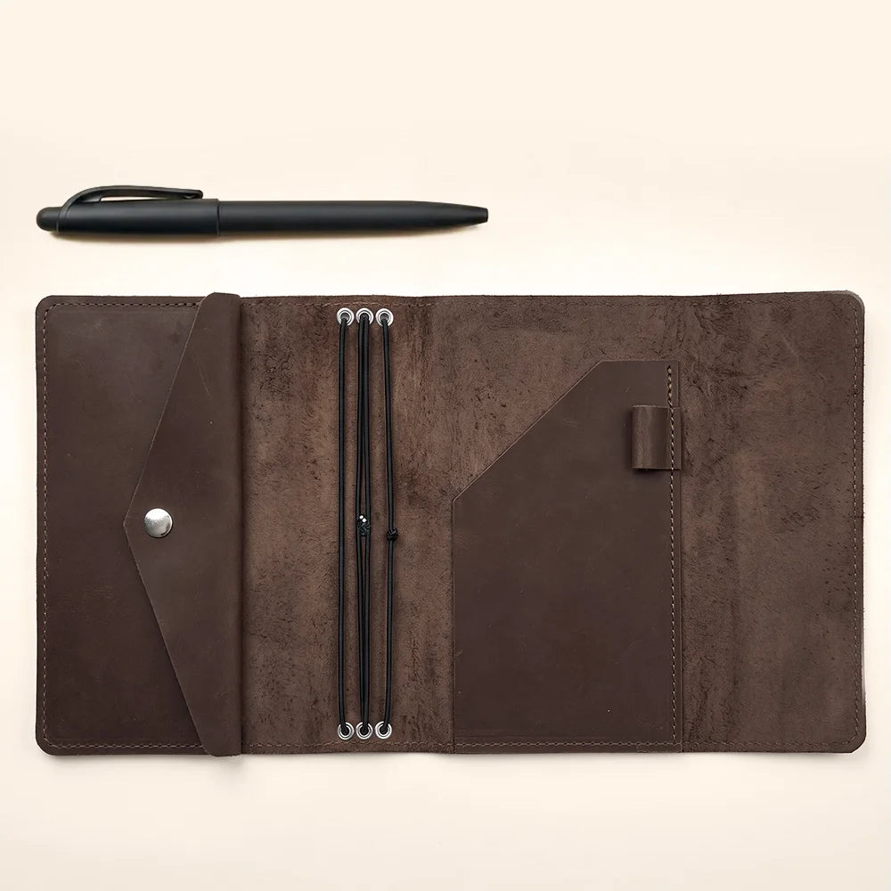 Vintage style leather journal organizer with interior sleeves and three durable elastic straps.