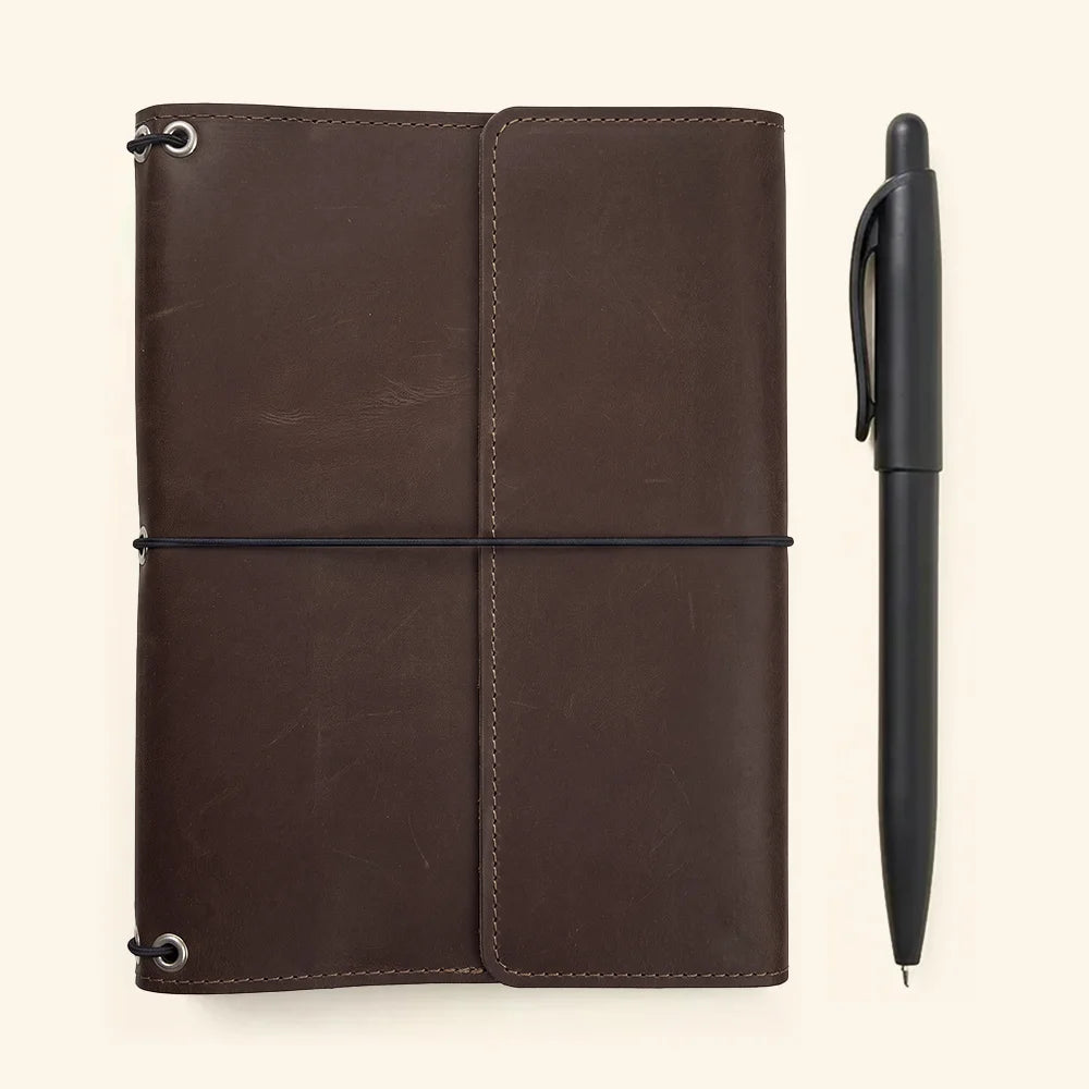 Handmade leather notebook holder with refillable design and convenient interior organization features.