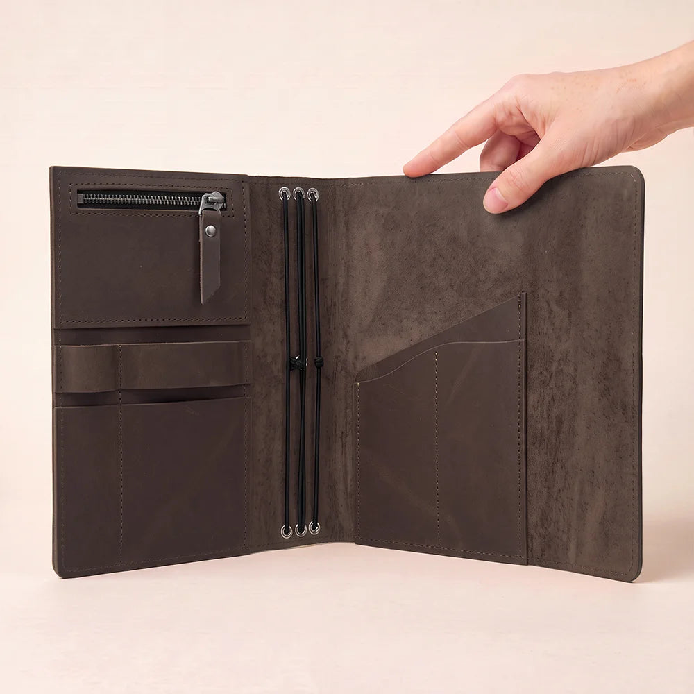 Natural hide notebook cover with built-in compartments for notes, cards, and writing accessories.
