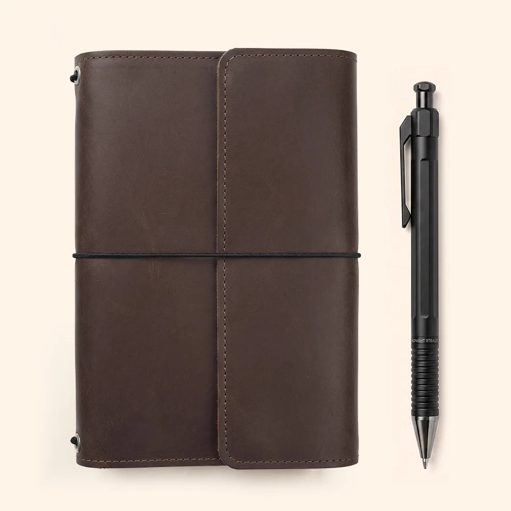 Leather planner cover featuring neatly positioned inner pockets and a dedicated holder for pens.