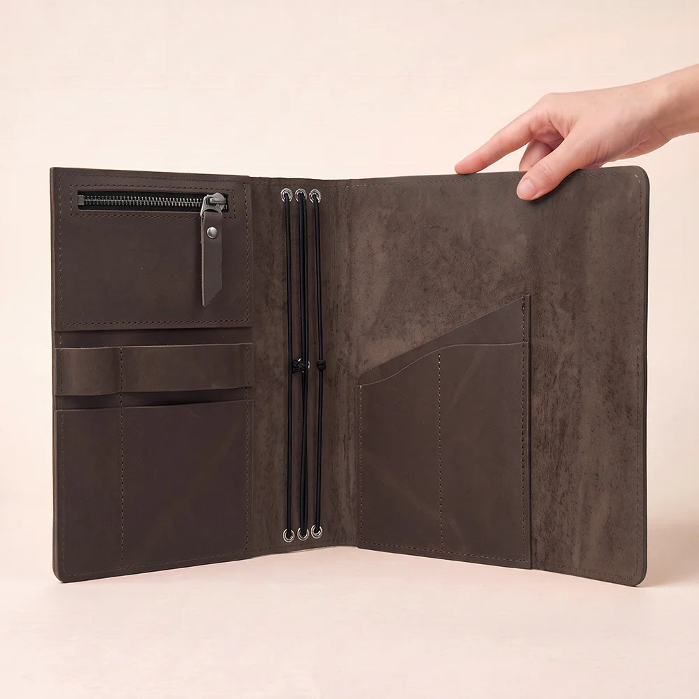Genuine leather planner cover with interior pockets designed for keeping small essentials organized.