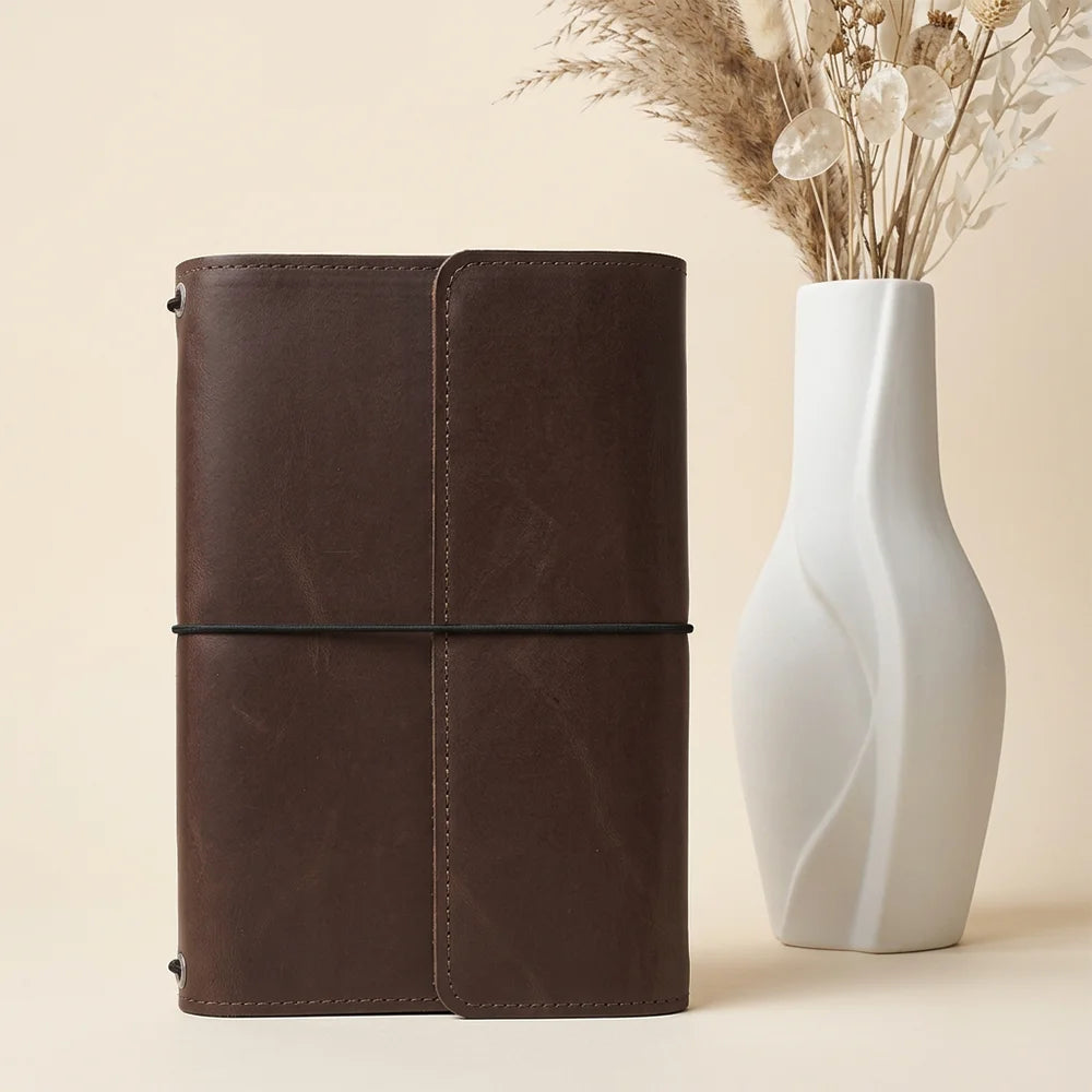 Natural leather journal organizer with useful pockets and integrated storage for everyday writing tools.