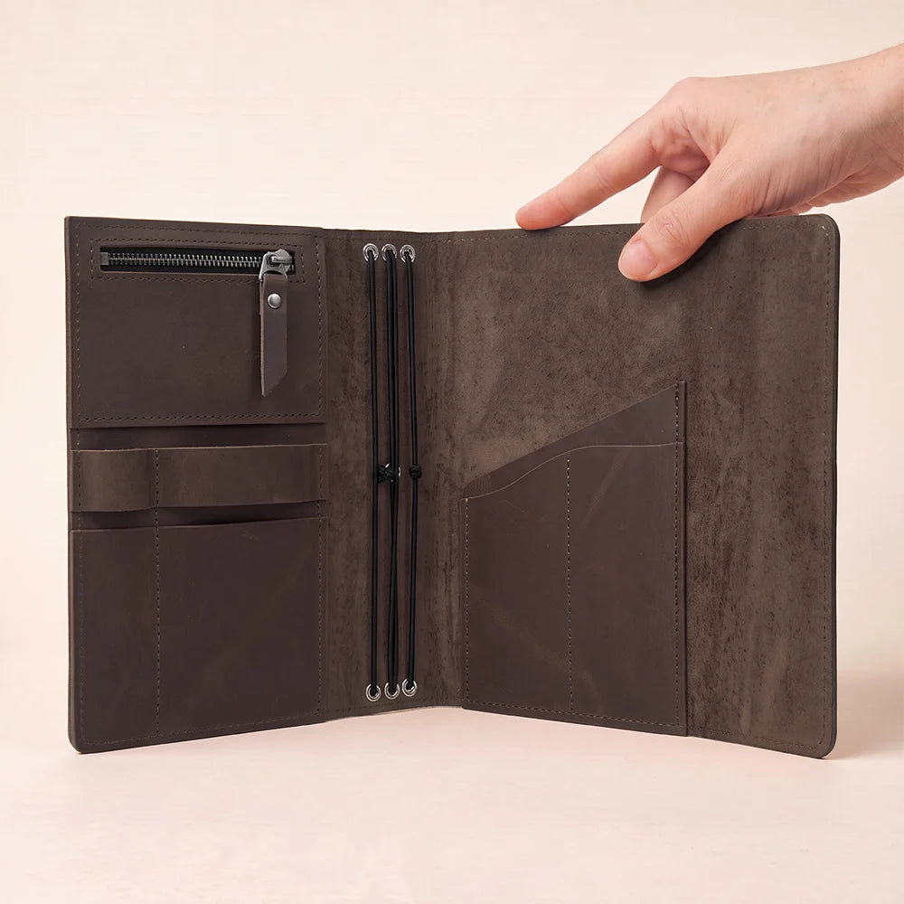 Natural leather notebook cover showing spacious pockets and a practical pen loop inside