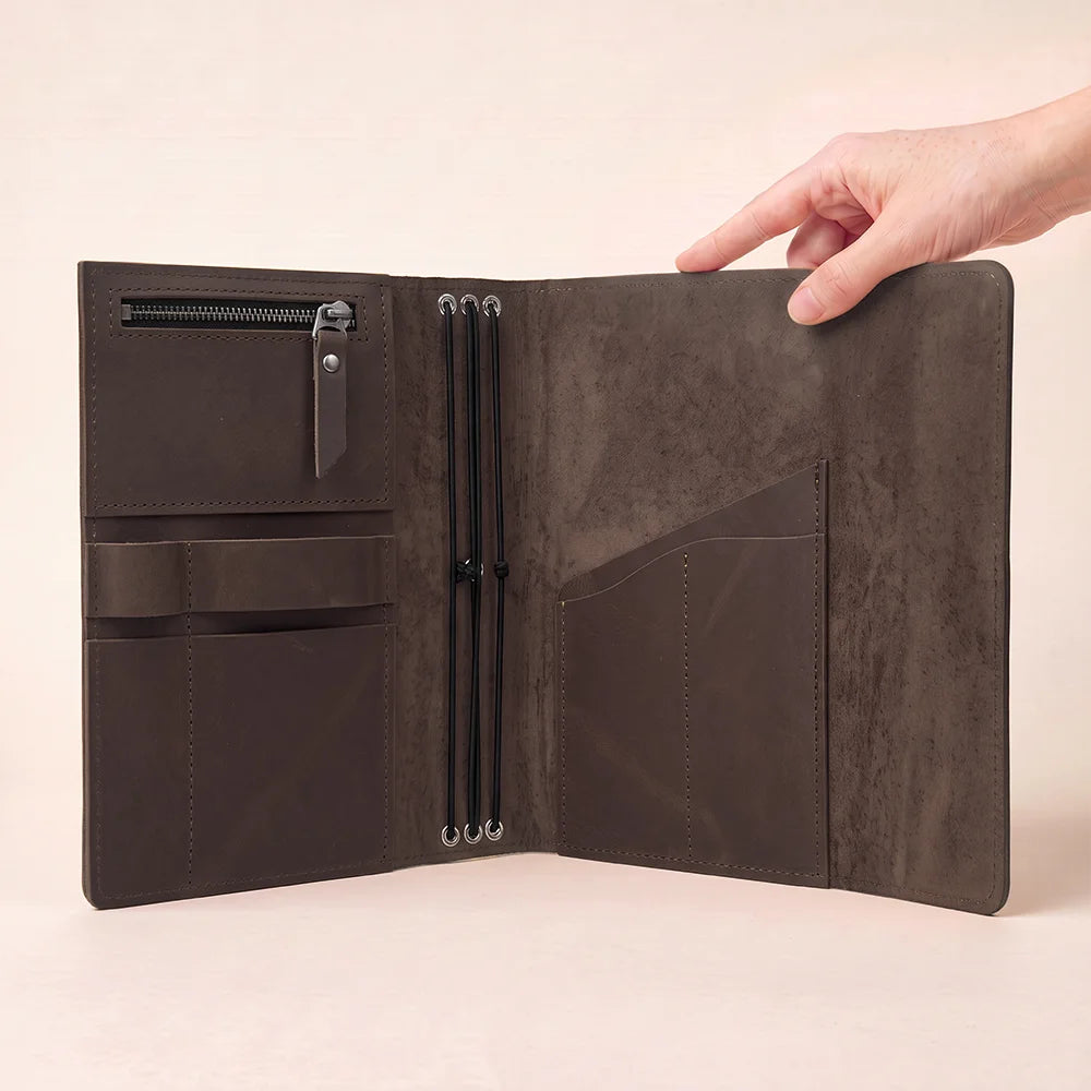 Leather notebook organizer with interior slots designed for cards, papers, and everyday writing supplies.