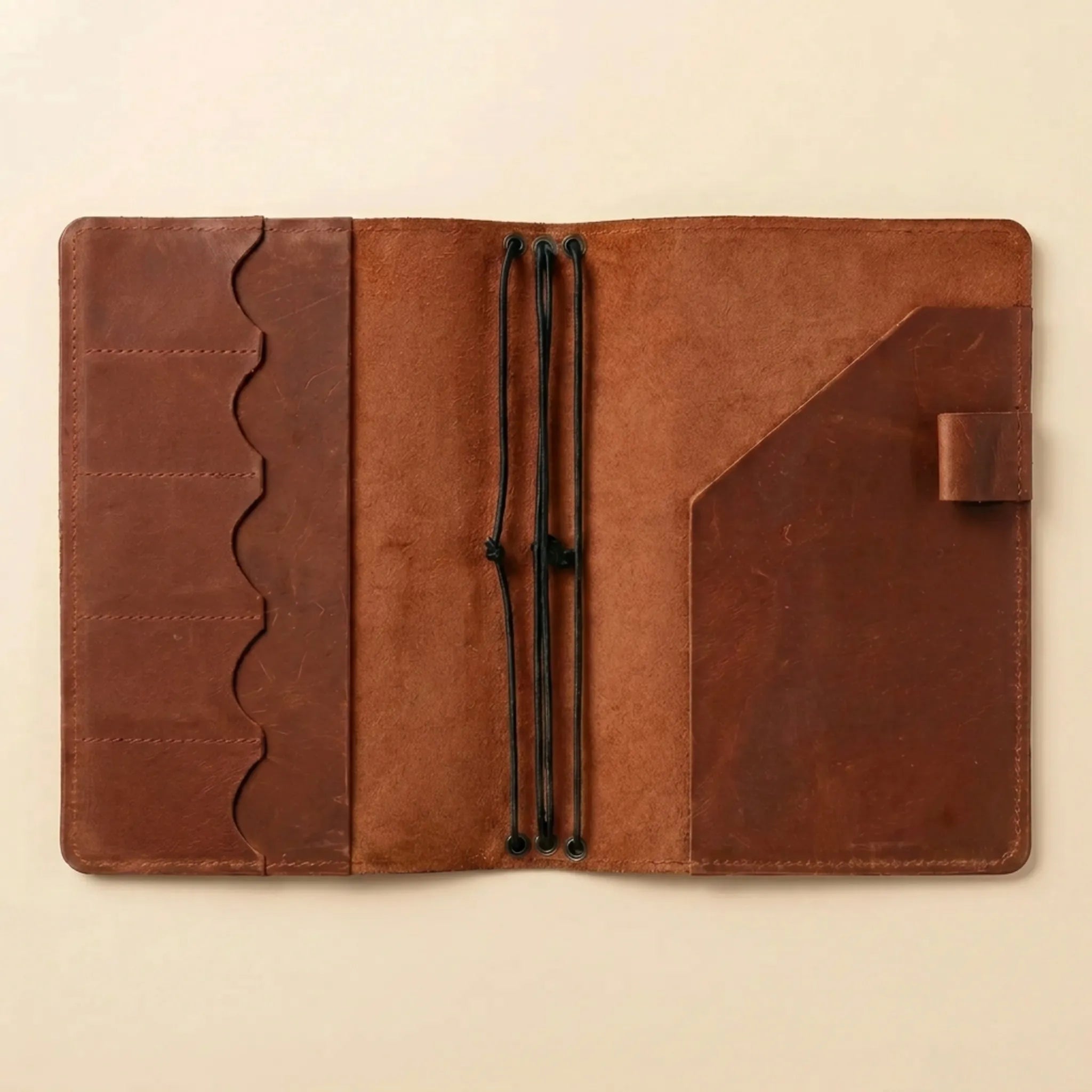 Genuine leather notebook wrap with flexible refillable journal insert system.