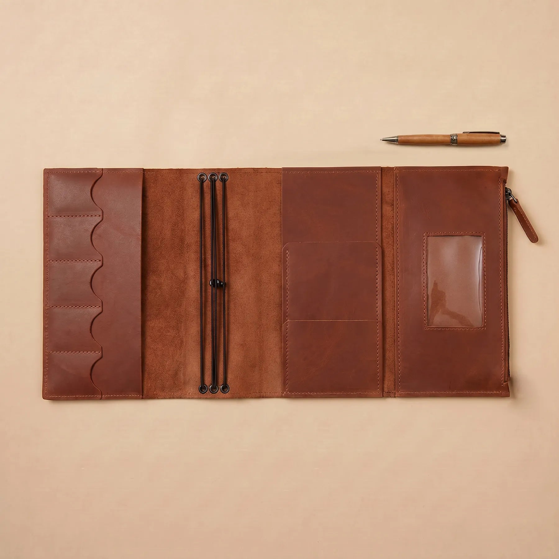 Rustic leather notebook organizer with refillable inserts for work and travel.