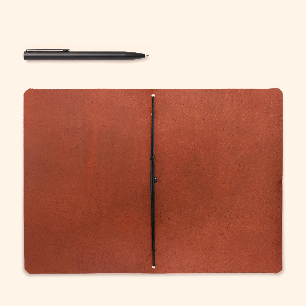 Leather writing case featuring a plain journal secured neatly within the cover.