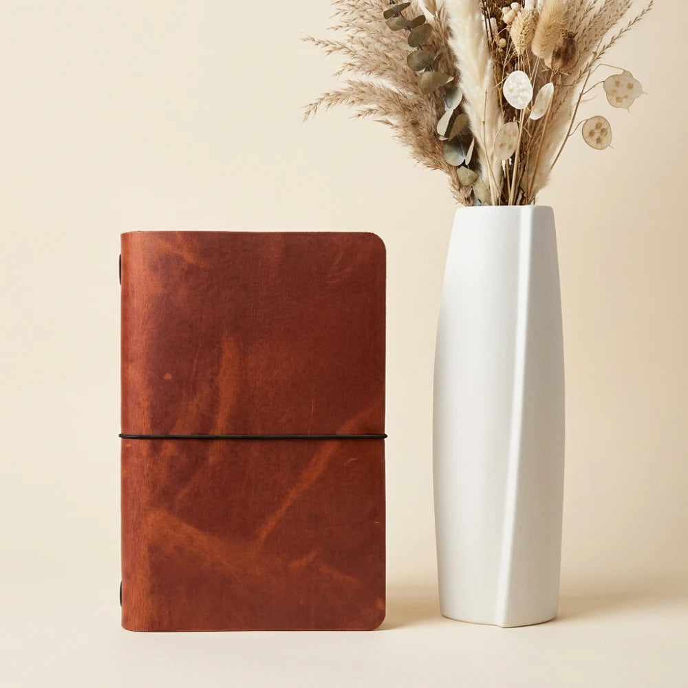 Leather writing wrap designed to securely hold a basic journal during everyday use.