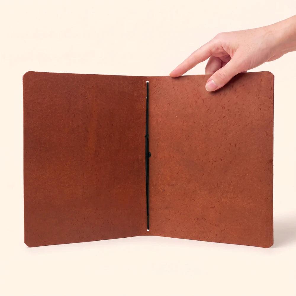 Slim journal cover crafted from genuine leather for portable notes and reflections.