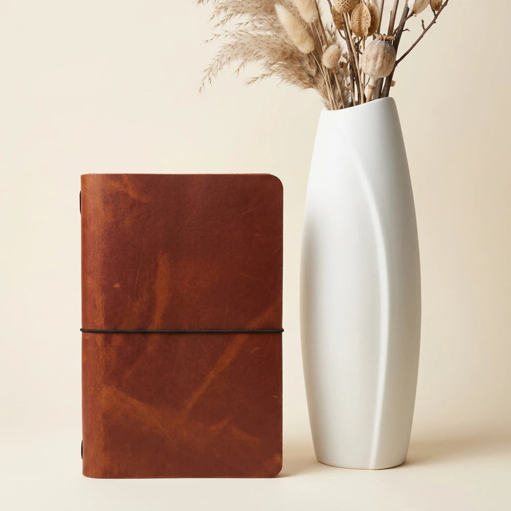 Handmade natural leather notebook cover featuring a minimalist design and one elastic band.