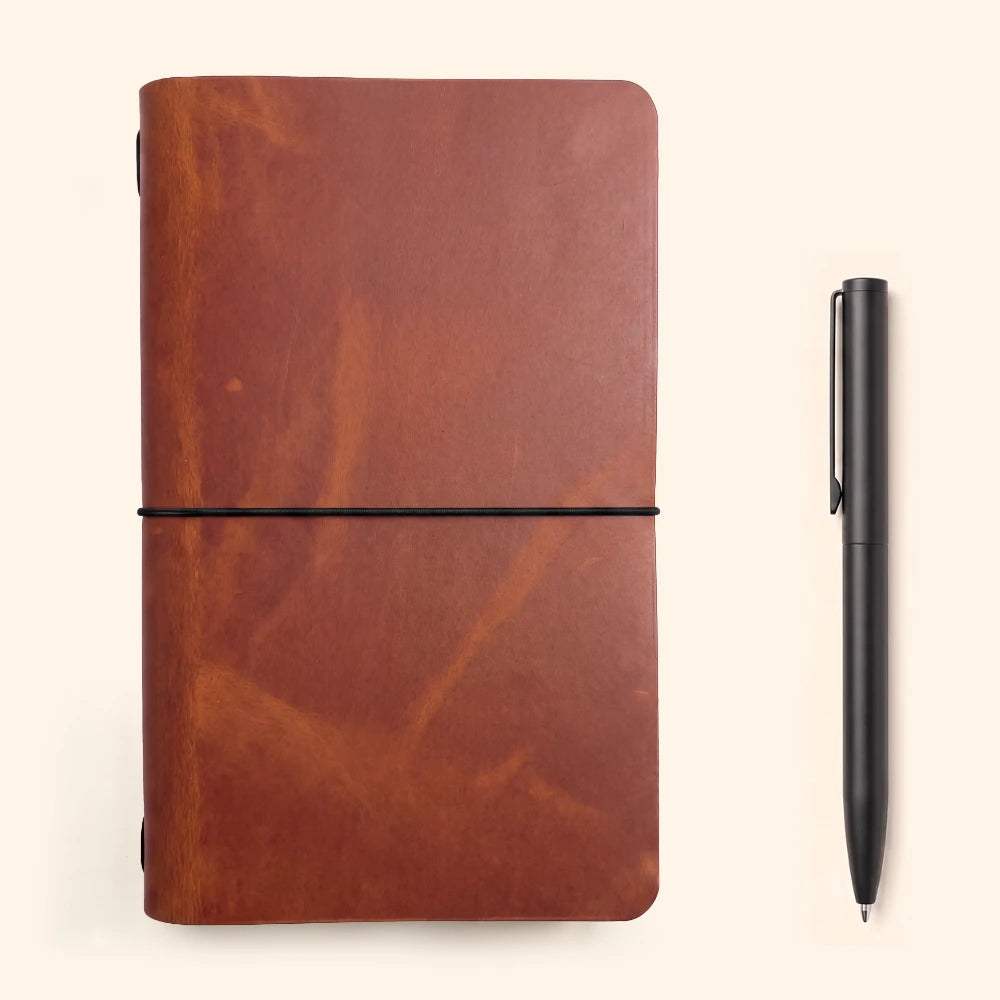 Handcrafted journal cover revealing a single elastic loop along the notebook spine.