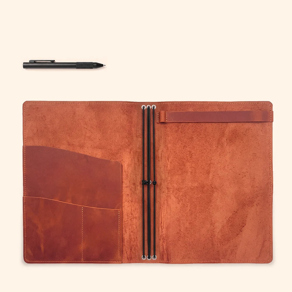 Natural leather journal holder opened to display a simple and organized interior.