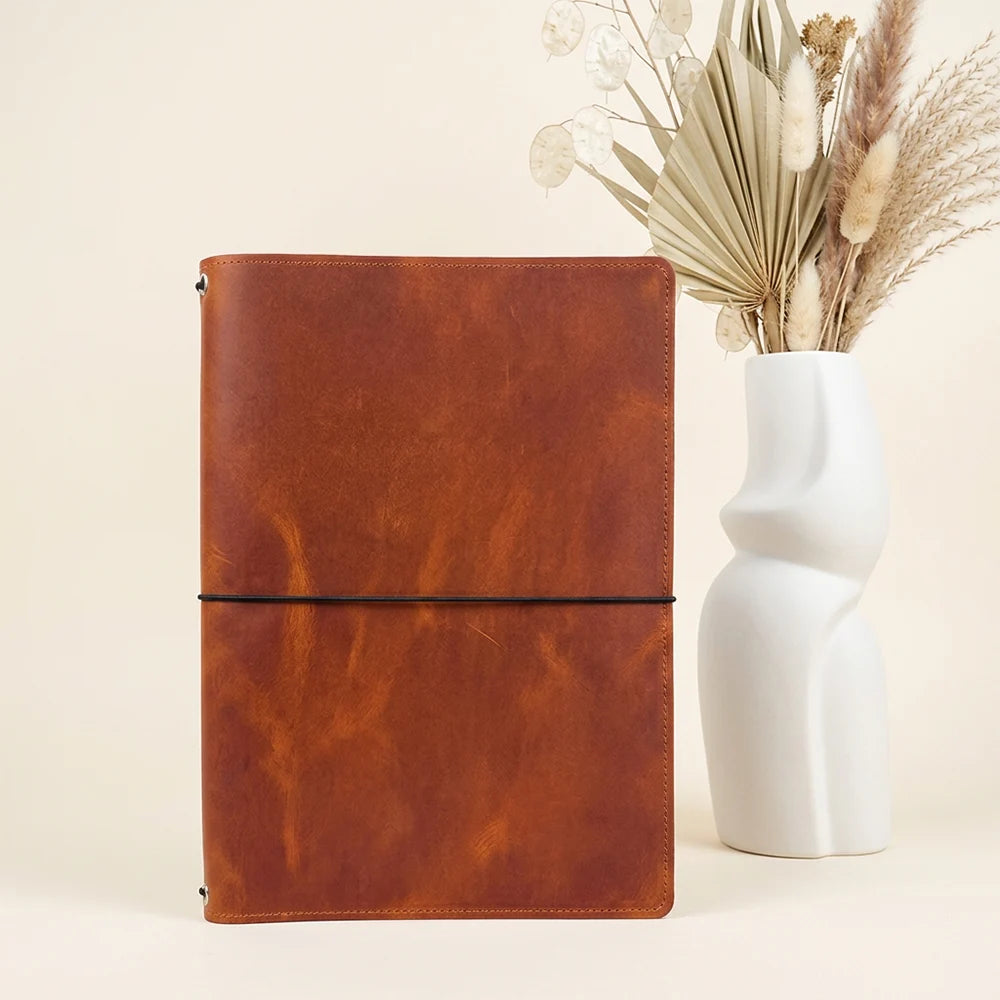 Genuine leather notebook organizer with dedicated space for inserts and a sketchbook.