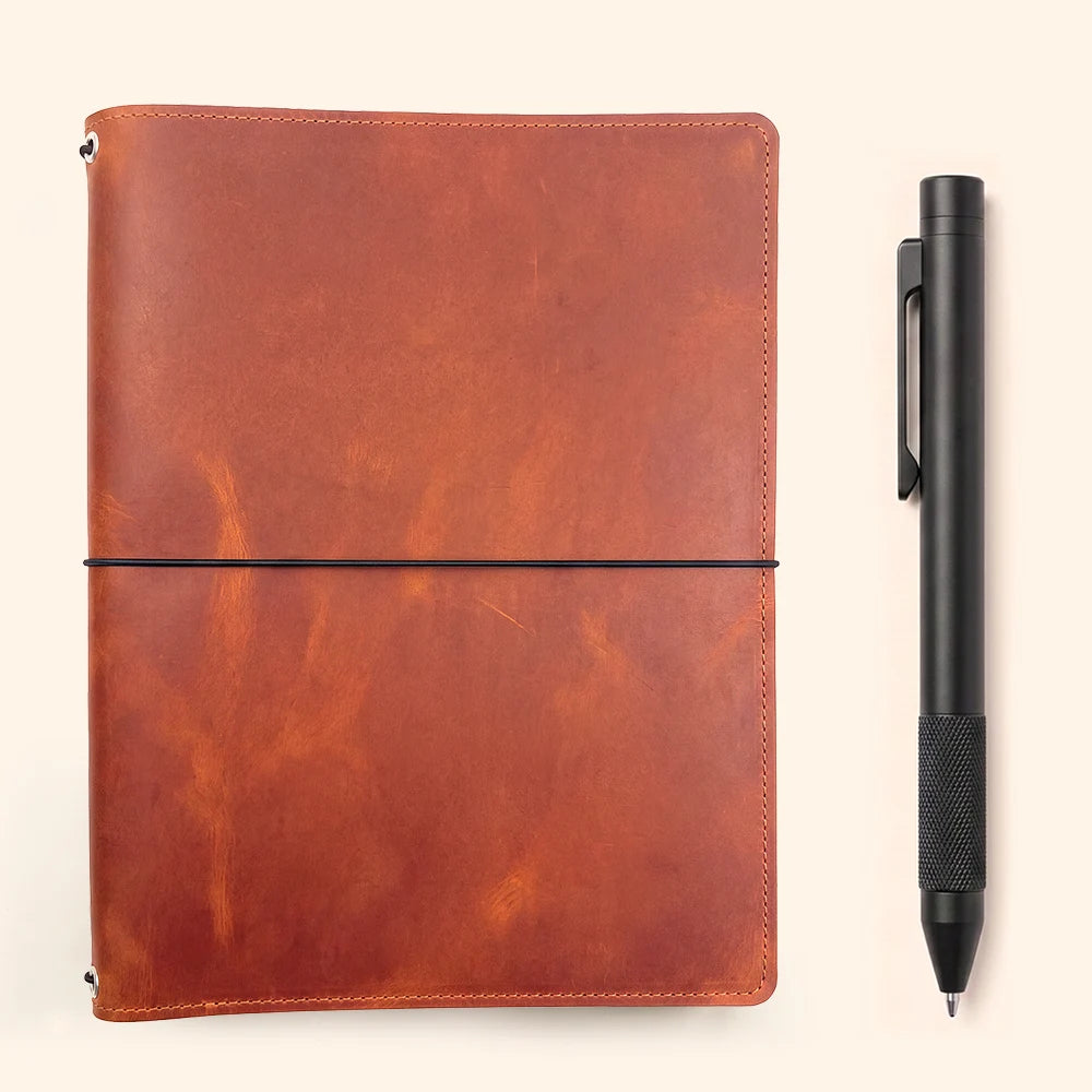 Refillable sketchbook cover with genuine leather construction and multiple elastic attachments.